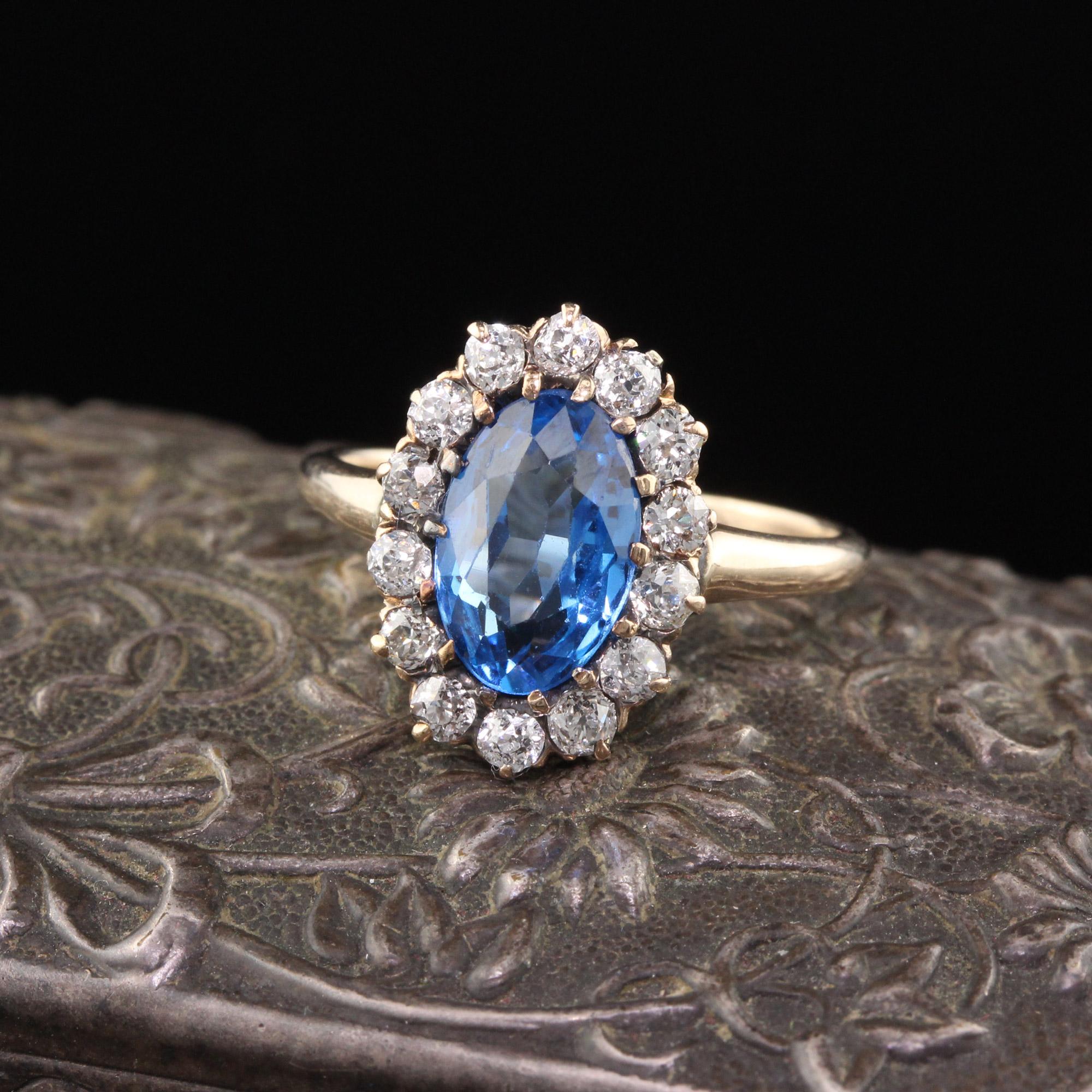 Amazing Victorian oval cluster ring with a captivating  bright blue synthetic spinel in the center surrounded by a halo of old cut diamonds. 

#R0155

Metal: 14K Yellow Gold 

Weight: 3.2 Grams

Total Diamond Weight: Approximately 0.45 cts

Ring