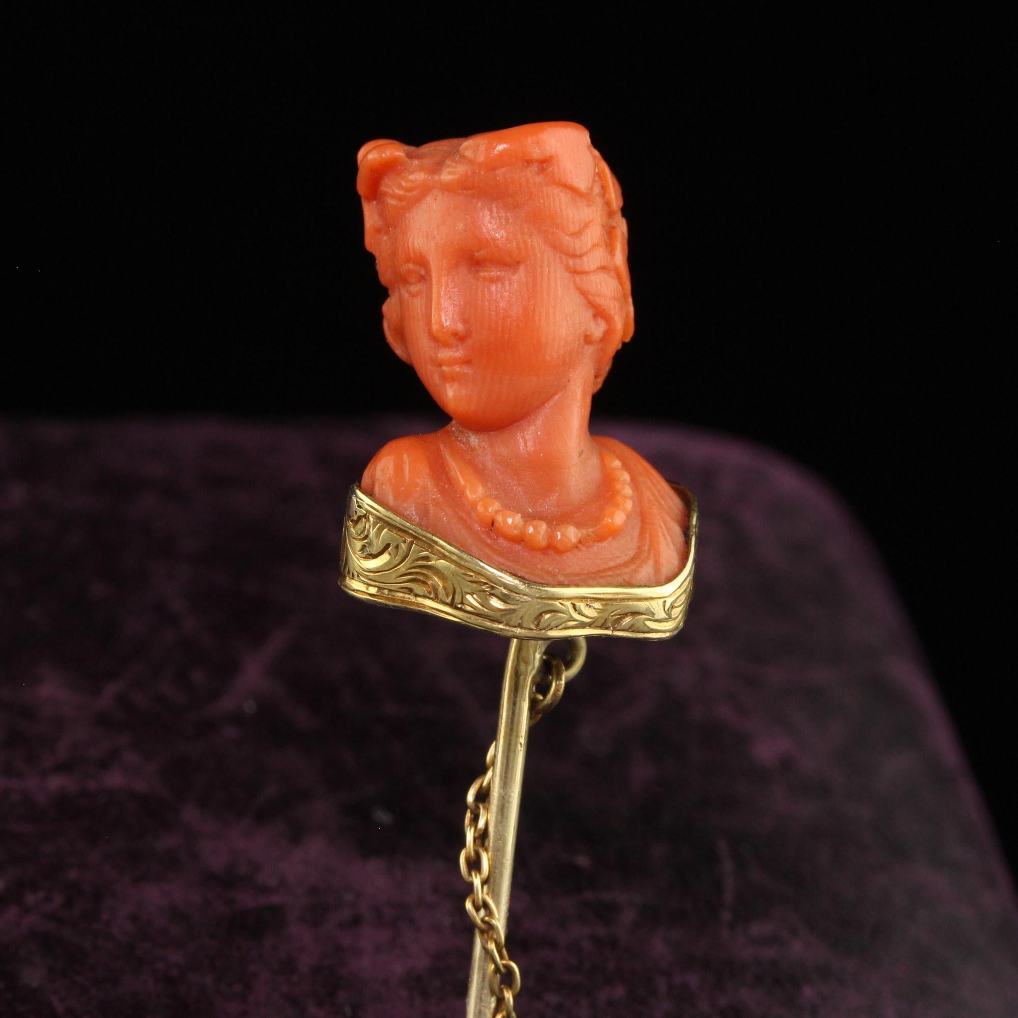Beautiful Antique Victorian 14K Yellow Gold Carved Coral Lady Stick Pin. This incredible Victorian stick pin is crafted in 14k yellow gold. The pin features a lady's bust carved from natural coral in incredible detail. The coral has a beautiful