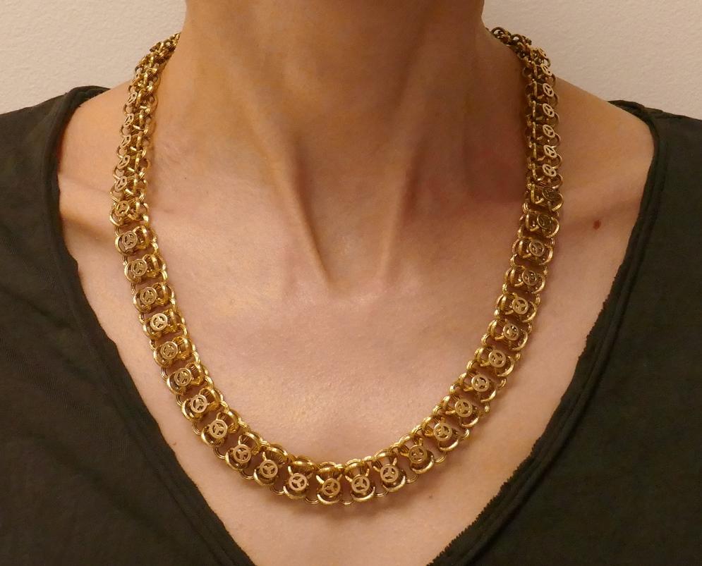 Whimsical antique chain necklace made of 14 karat yellow gold. Has unique, both textured and polished, links.
Measurements: 22 x 1/2 inches (55.6 x 1.3 cm).
Weight: 34.2 grams.