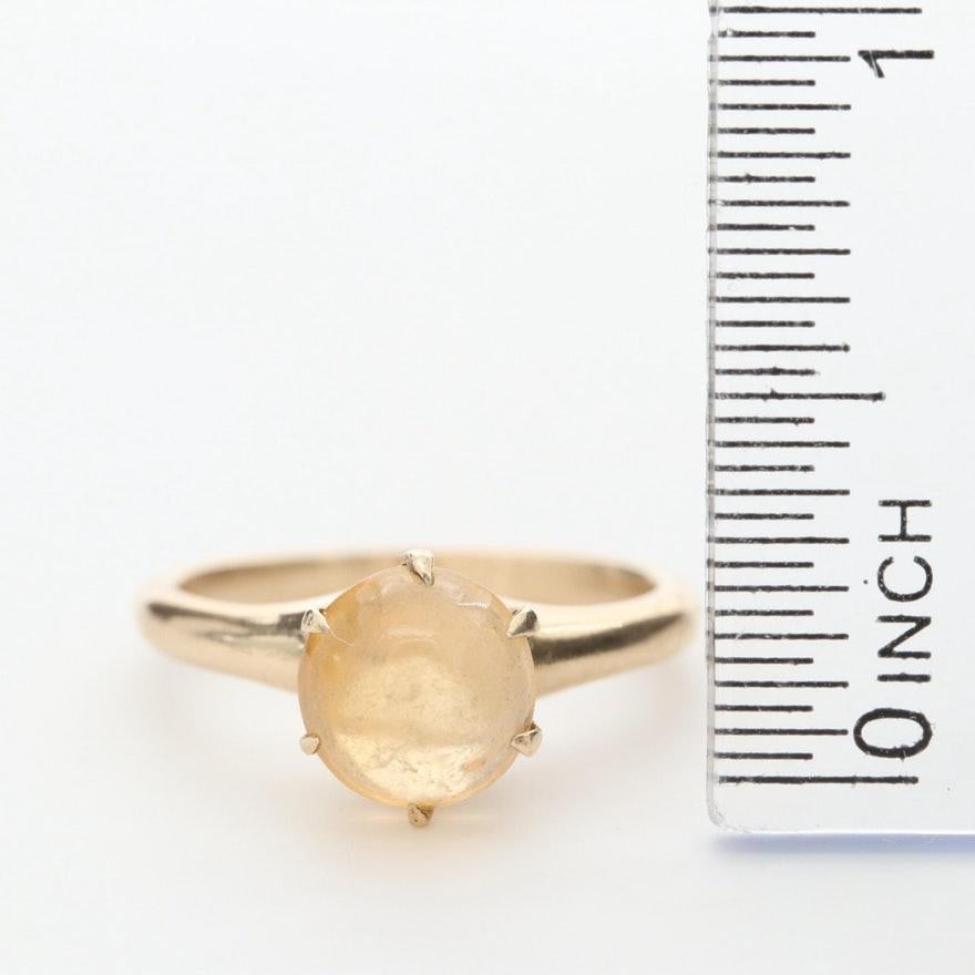 Item Details
Style:	Vintage
Materials:	14K Yellow Gold
Hallmarks:	14K
Total Weight:	2.40 dwt
 	 
Center Stone Type:	Opal
Center Stone Shape:	Round Cabochon
Center Stone Count:	1
Center Stone Dimensions:	8.00 mm

This ring can be sized up or down 3