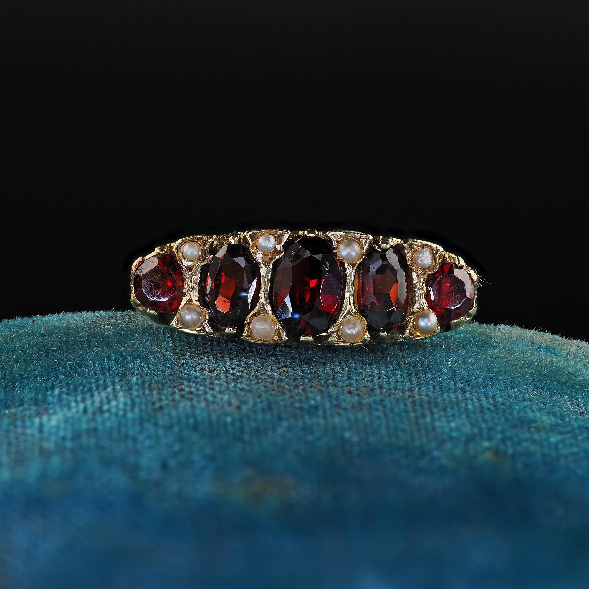 Beautiful Antique Victorian 14K Yellow Gold Garnet and Seed Pearl Five Stone Ring. This amazing Victorian garnet and seed pearl five stone ring is crafted in 14k yellow gold. The ring features five oval old cut garnets with seed pearls set in