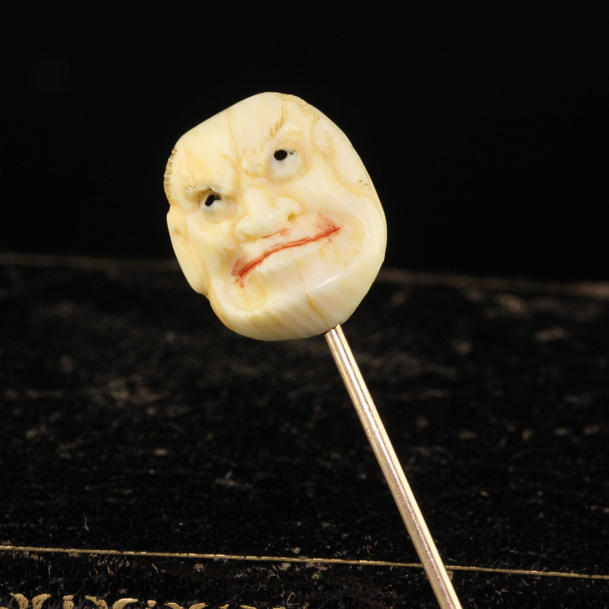 Beautiful Antique Victorian 14K Yellow Gold Japanese Carved Bone Hyottoko Stickpin. This incredible stick pin is crafted in 14k yellow gold. The pin features a Japanese face of a woman on one side and a man on another which was a form of theatre