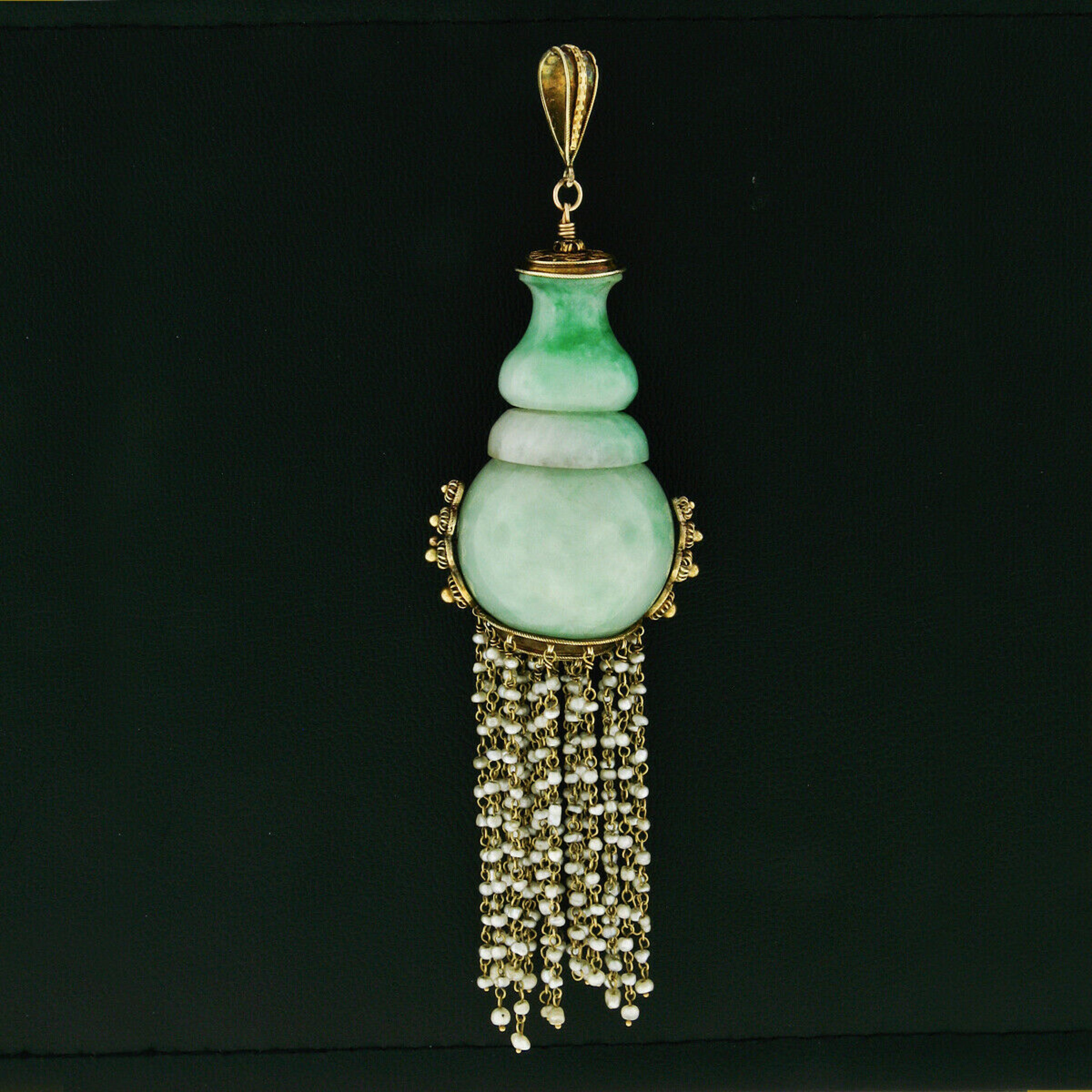 This large antique pendant was crafted from solid 14k yellow gold during the Victorian era and features 2 large natural jadeite stones which are strung together. One of the 2 jadeite stones was randomly selected by GIA for testing and has been