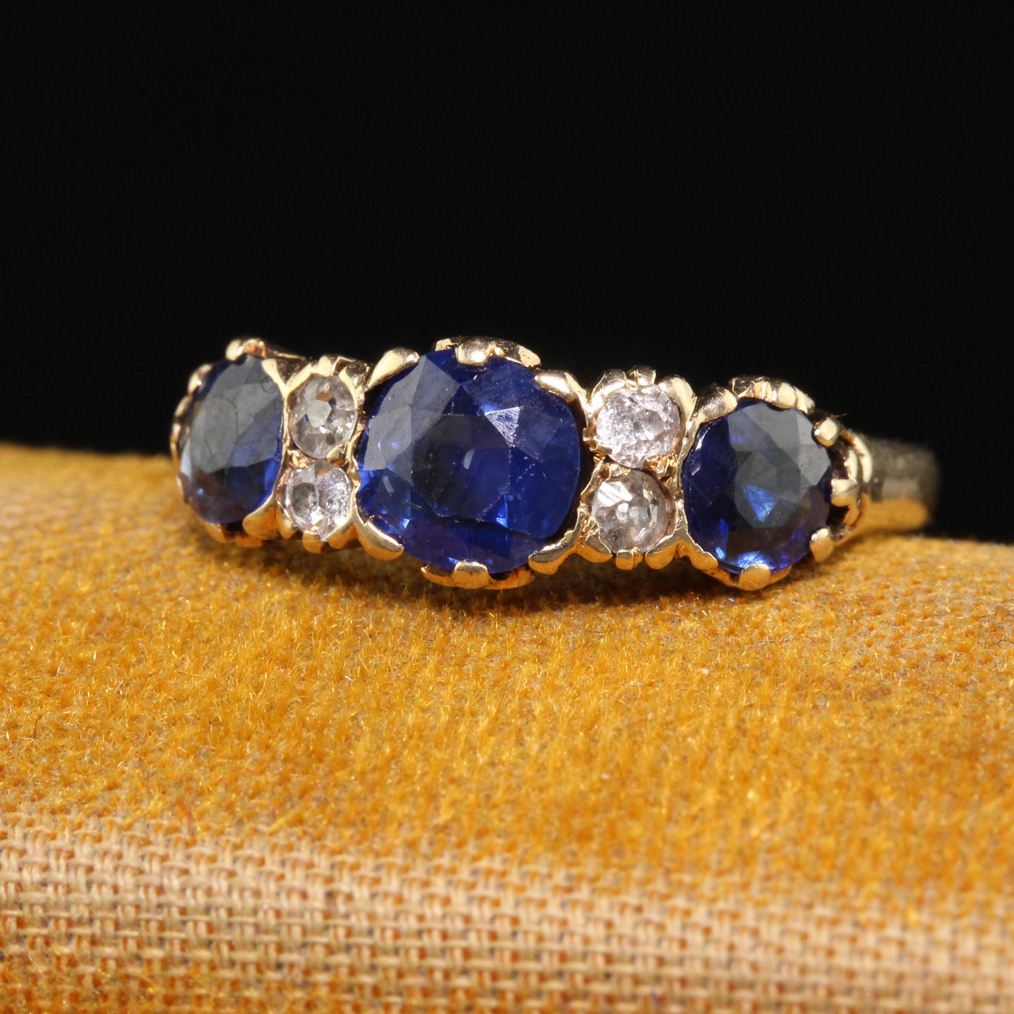 Beautiful Antique Victorian 14K Yellow Gold Natural Sapphire and Diamond Three Stone Band - Size 4 3/4. This gorgeous Victorian three stone band is crafted in 14k yellow gold. The top of the ring has three old cut sapphires that are a beautiful hue