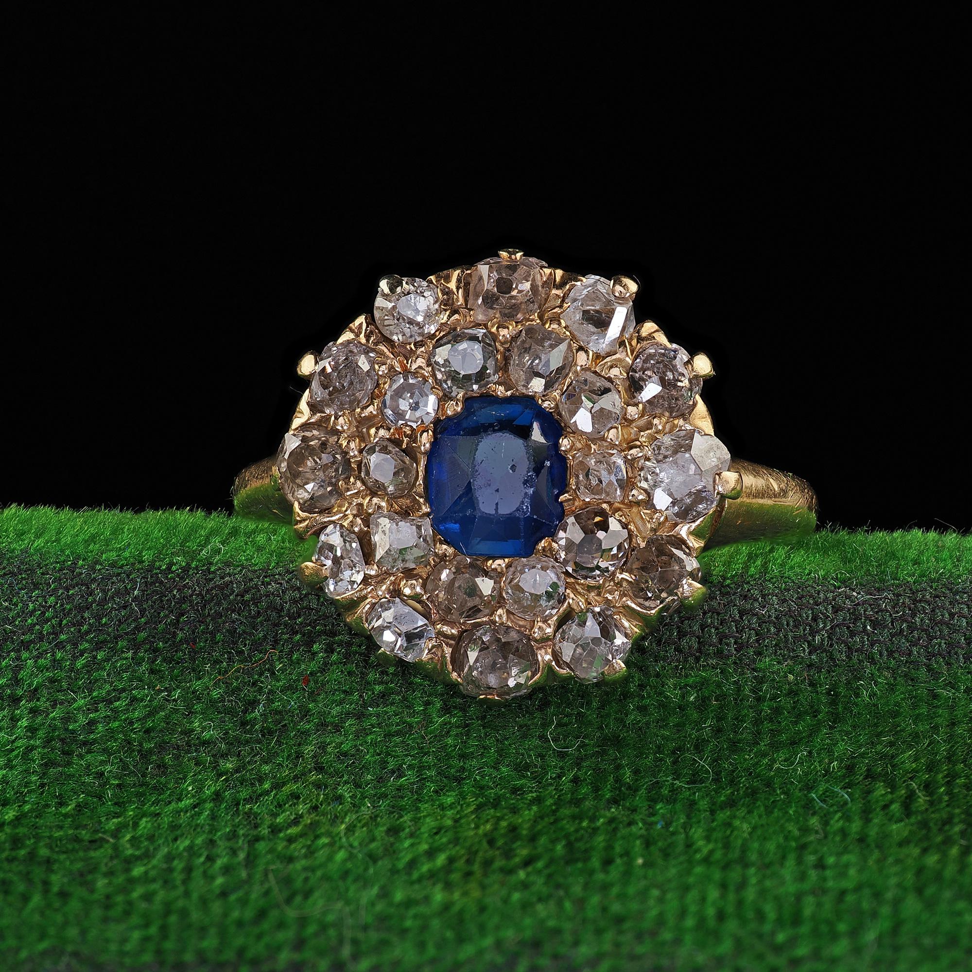 Beautiful Antique Victorian 14K Yellow Gold Old Cut Diamond and Sapphire Cluster Ring. This gorgeous Victorian diamond and sapphire cluster ring is crafted in 14k yellow gold. The ring features a natural sapphire in the center and is surrounded by