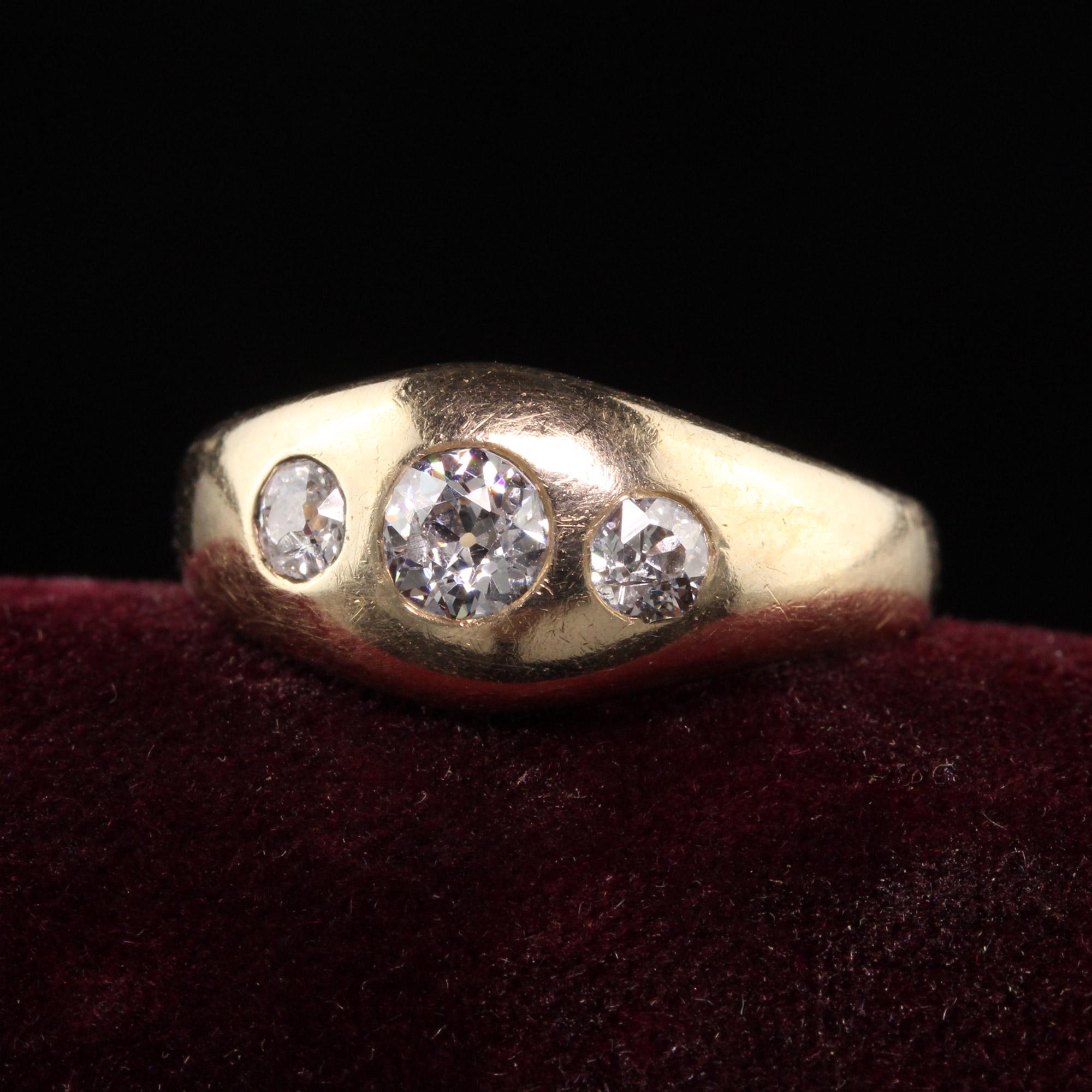 Beautiful Antique Victorian 14K Yellow Gold Old Mine Cut Diamond Three Stone Gypsy Ring. This beautiful ring is crafted in 14K yellow gold and has three old mine cut diamonds on the top that is bezel set. This ring is commonly called a gypsy ring