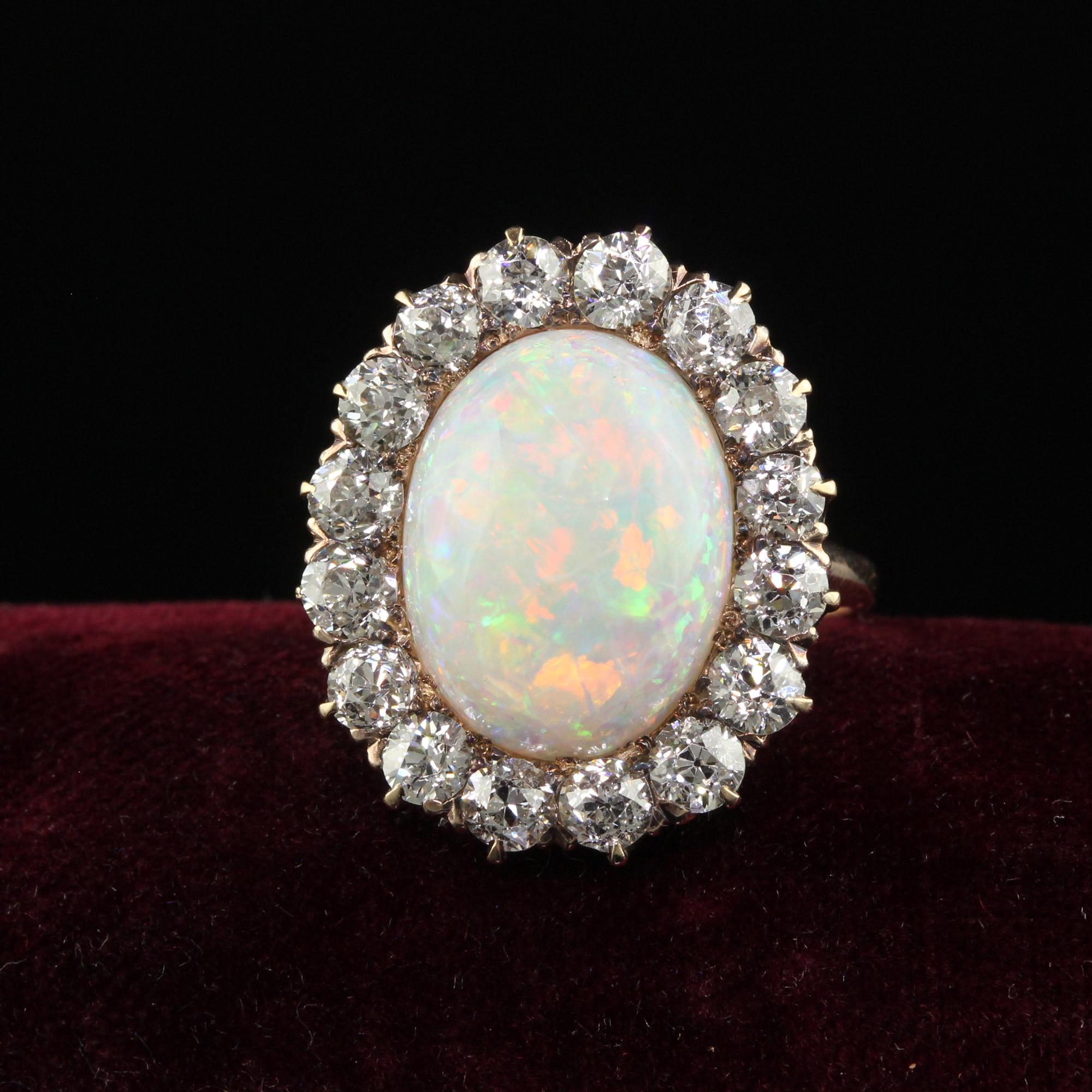 Beautiful Antique Victorian 14K Yellow Gold Old Mine Diamond and Opal Cocktail Ring. This gorgeous Victorian old mine diamond and opal ring is crafted in 14k yellow gold. The ring features a beautiful natural opal with a beautiful play of color. The