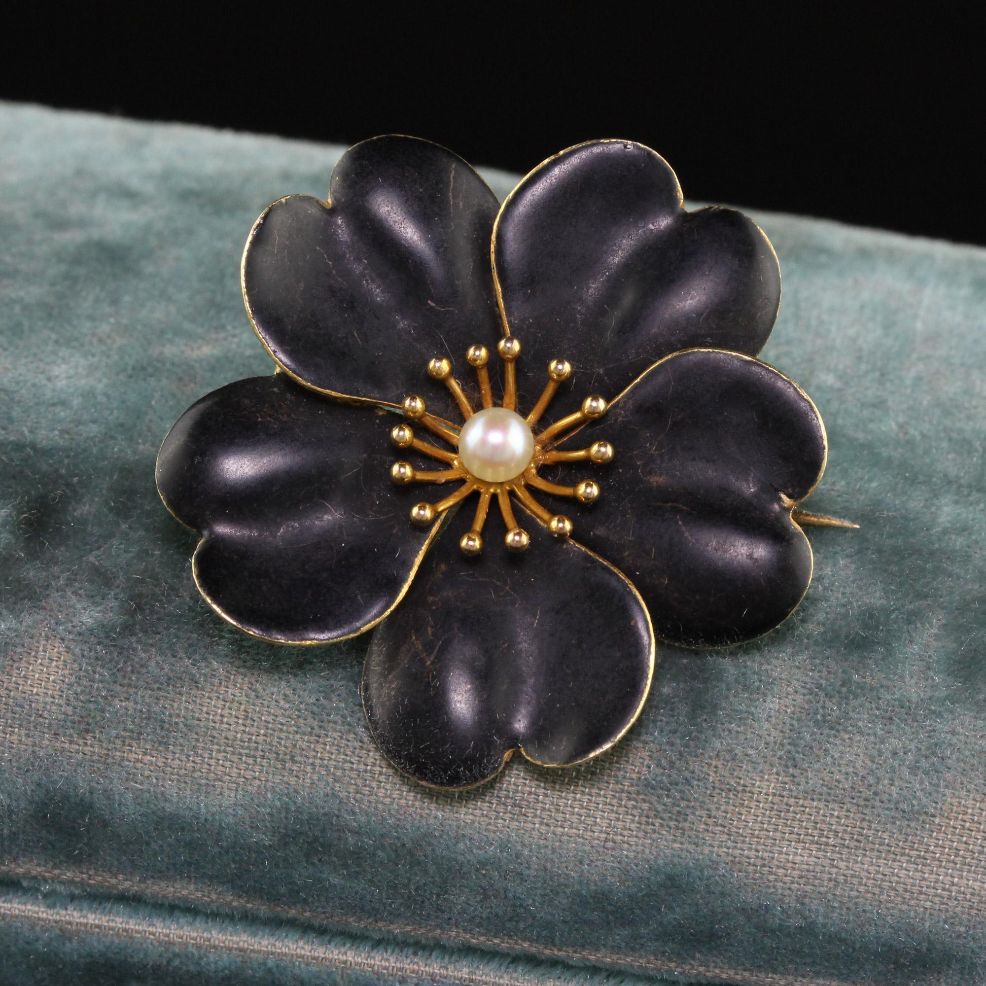 Beautiful Antique Victorian 14K Yellow Gold Pearl Black Enamel Flower Pin. This gorgeous pin is crafted in 14k yellow gold. The pin has a pearl in the center of a flower that features black enamel on the petals which is very rare to see. There