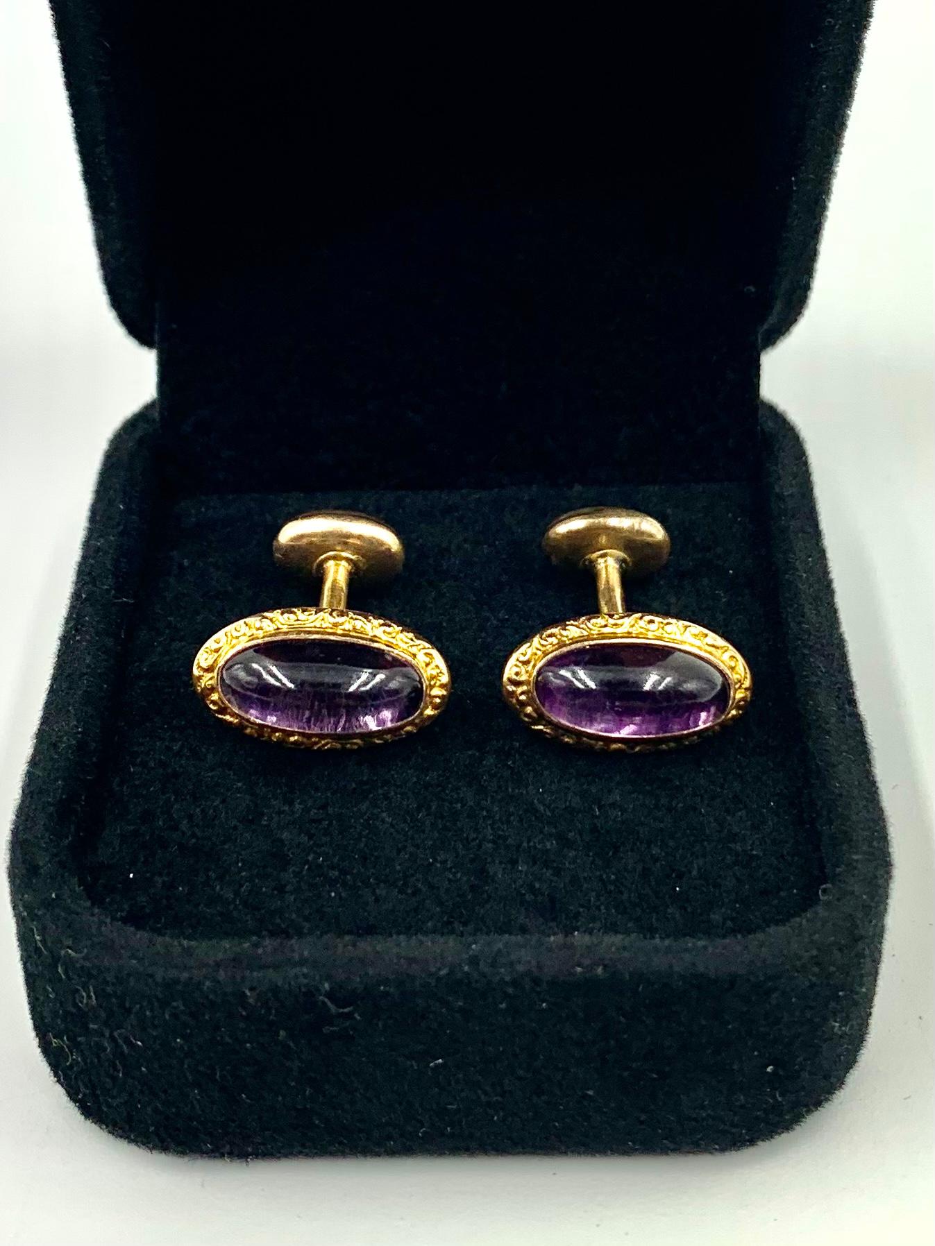 Circa 1880 
14K yellow gold repousse scroll oval cabochon amethyst cufflinks
Victorian Period
Tested for 14K gold, makers marks on each connector
Very good condition commensurate with age, some age appropriate oxidation visible to the back with one