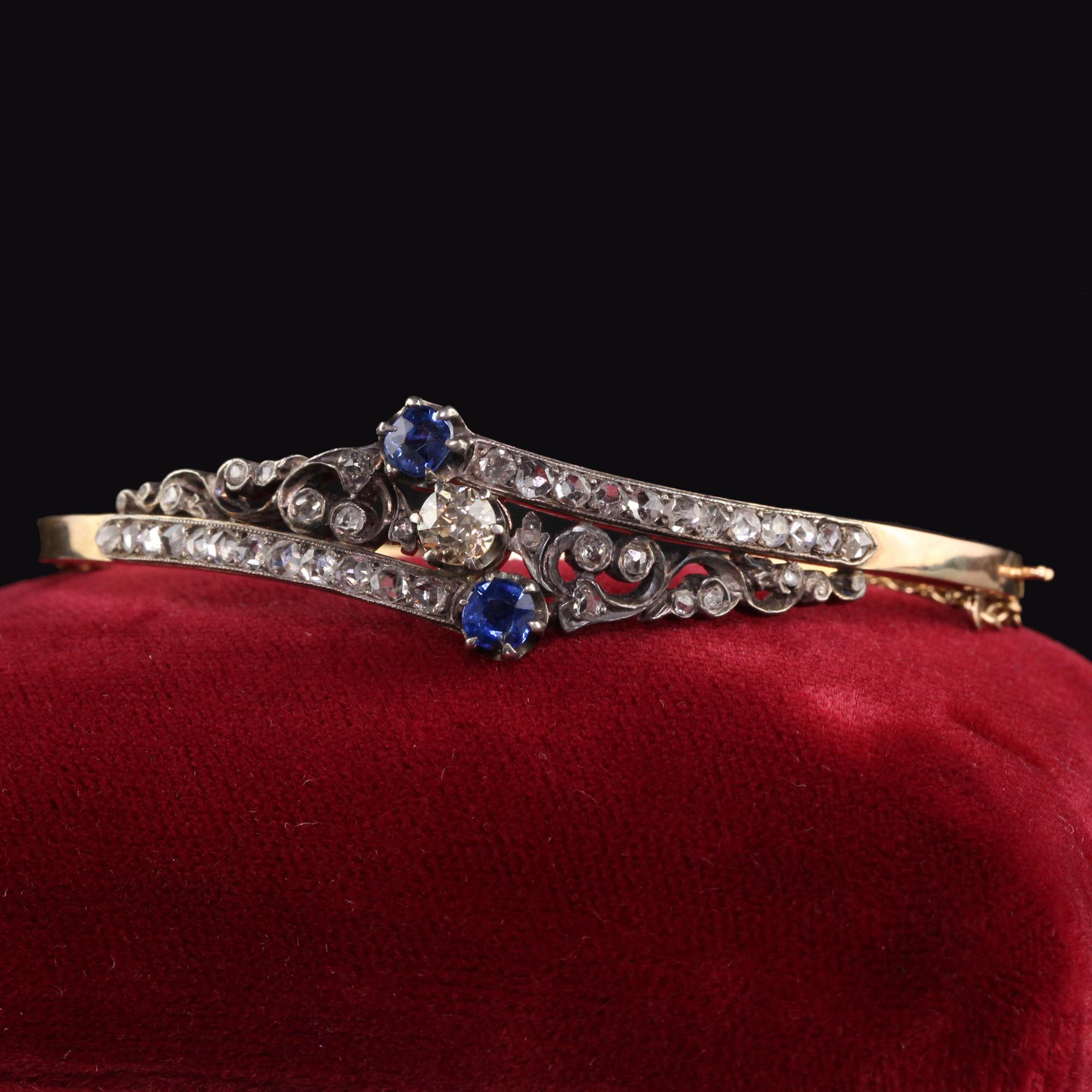 Beautiful Antique Victorian 14K Yellow Gold Rose Cut Diamond and Sapphire Bangle Bracelet. This gorgeous bangle bracelet is crafted in 14k yellow gold and silver top. There are chunky rose cut diamonds all over the bangle with a champagne old euro