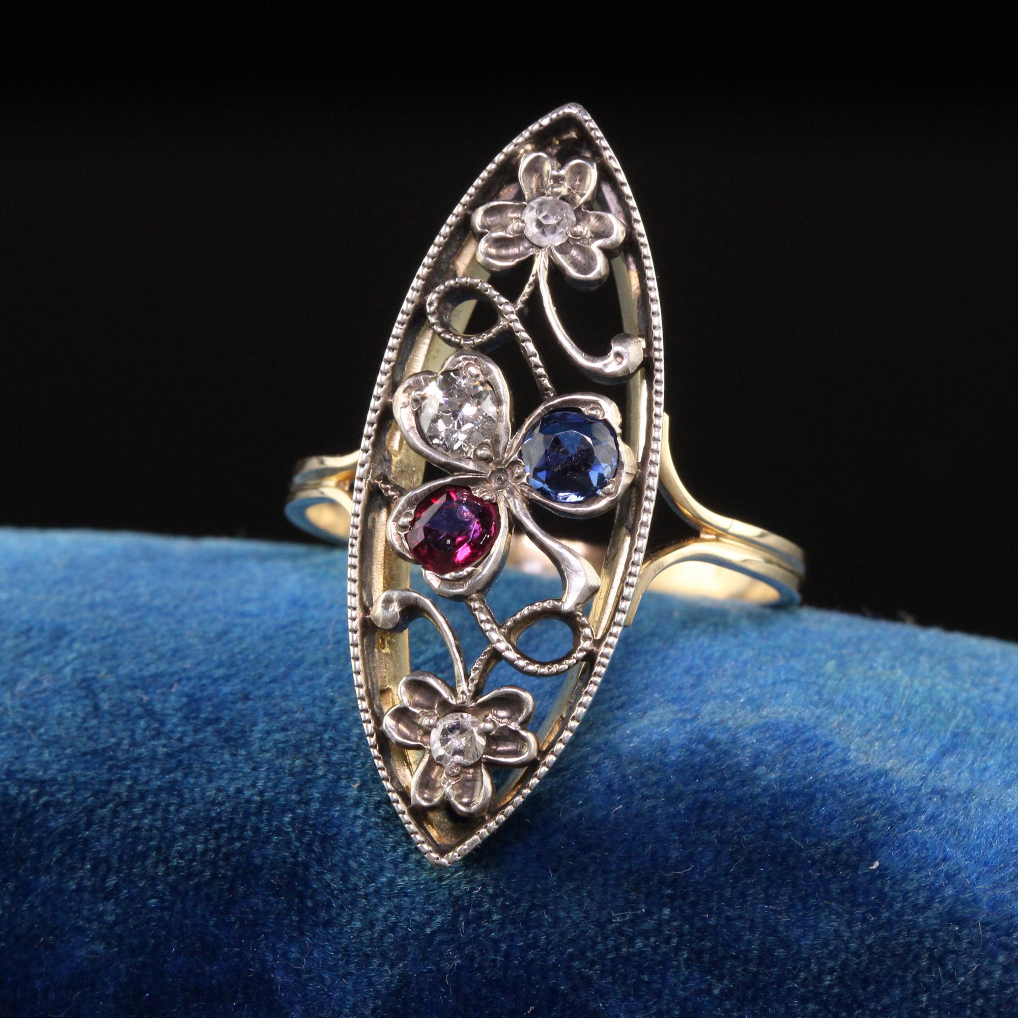 Beautiful Antique Victorian 14K Yellow Gold Silver Top Old Cut Diamond Ruby Sapphire Ring. This incredible ring is crafted in 14k yellow gold and silver top. There are old european cut diamonds set next to a natural ruby and sapphire in the clover