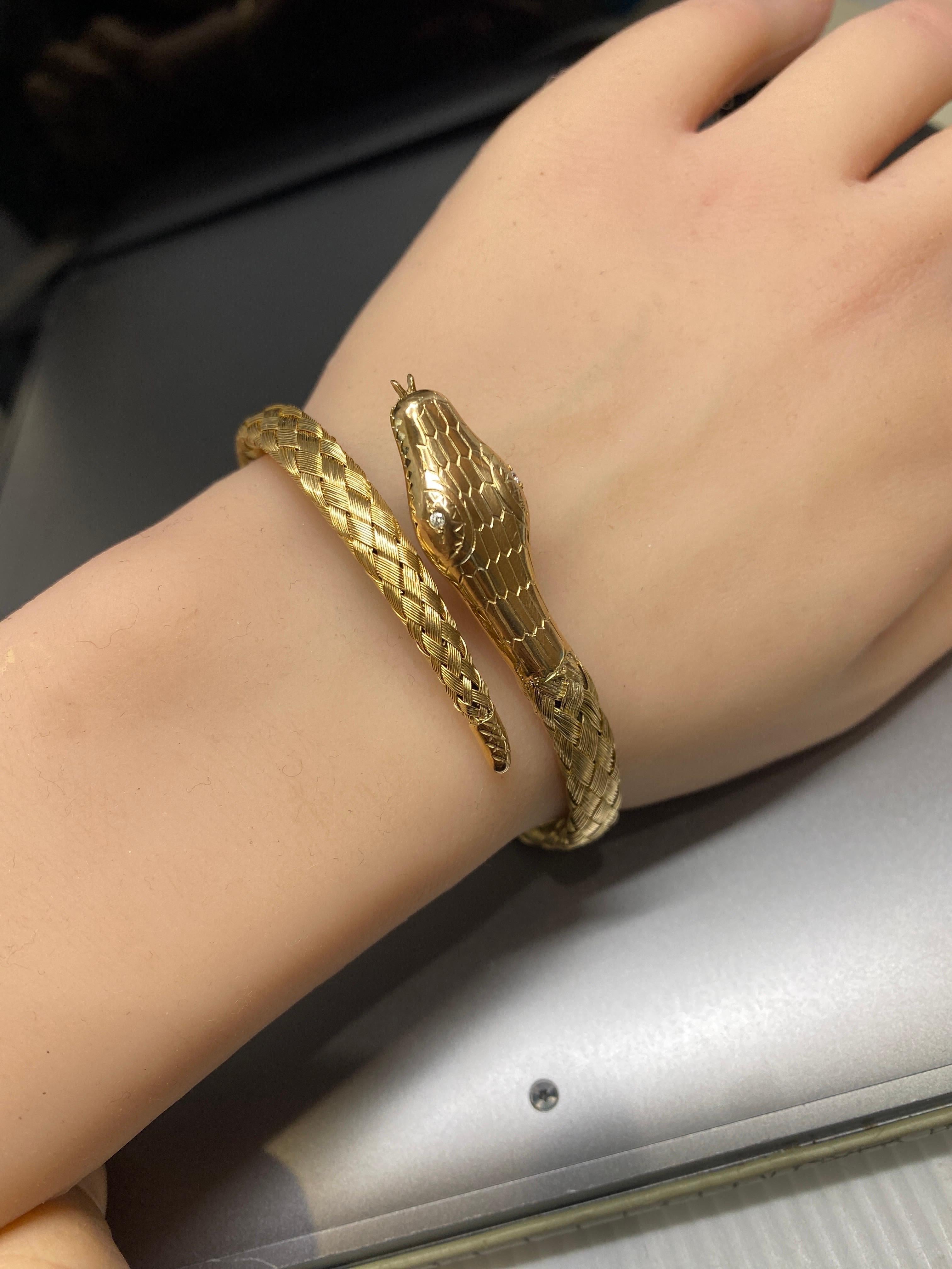 This antique Victorian Woven Snake Wrap Coil Bracelet is crafted in lustrous  14k Yellow Gold.   It features two sparkling diamonds as eyes and detailed with a forked tongue peaking out of it's mouth.  The head is adorned with scale engravings on