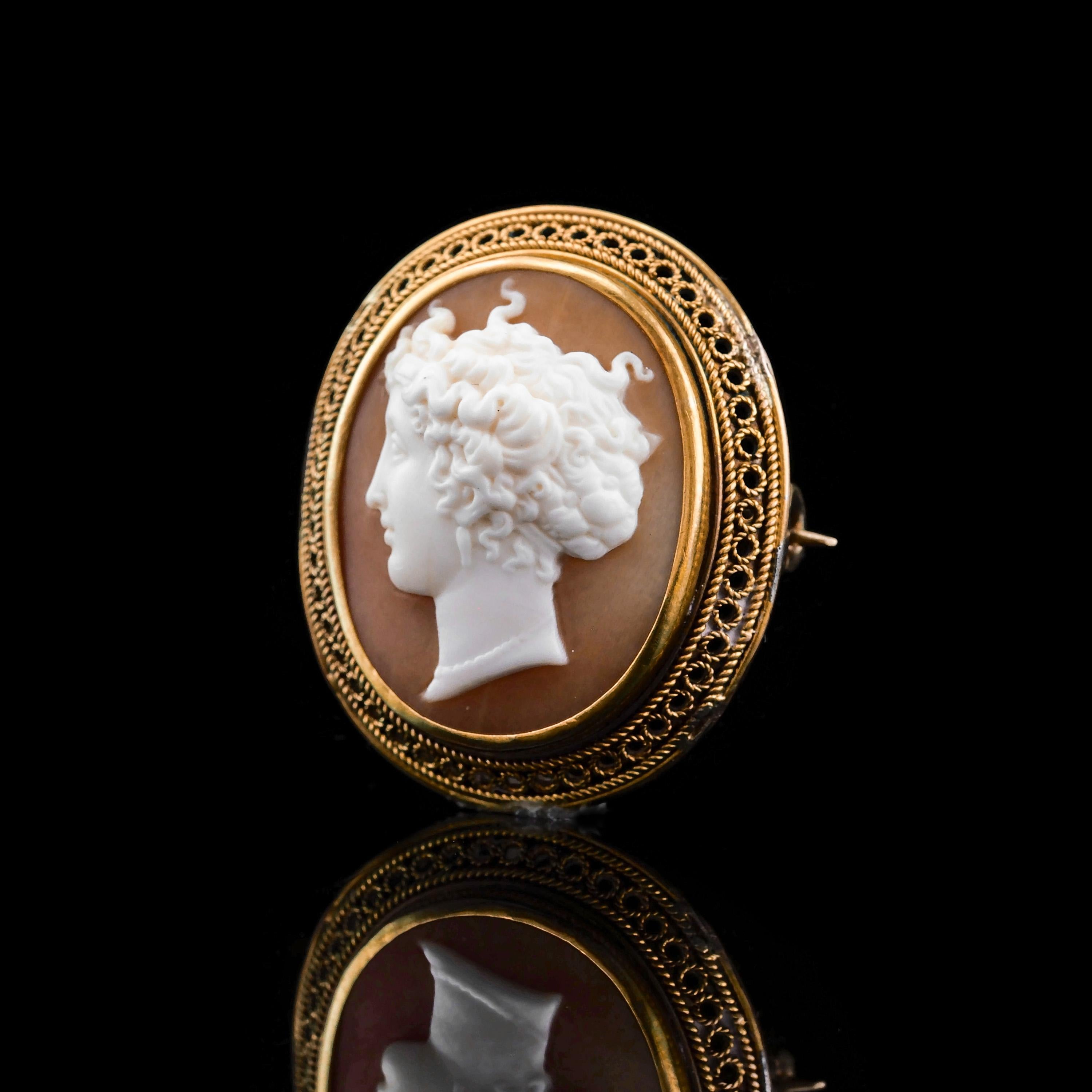 We are delighted to offer this beautiful 15ct gold Victorian shell cameo made c.1890. 
 
The cameo features a delightful peach-like colour with the figural head being intricate and elegantly engraved.
 
Despite its small and compact size, the