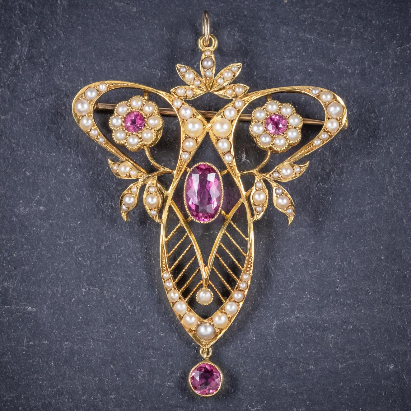 A fabulous antique Victorian floral pendant/ brooch C. 1900, set with Pink Tourmalines and lovely natural Pearls. 

The central pink Tourmaline is approx. 1ct with a 0.22ct dropper and two 0.10ct stones crowned upon flowers. 

The gallery is stamped