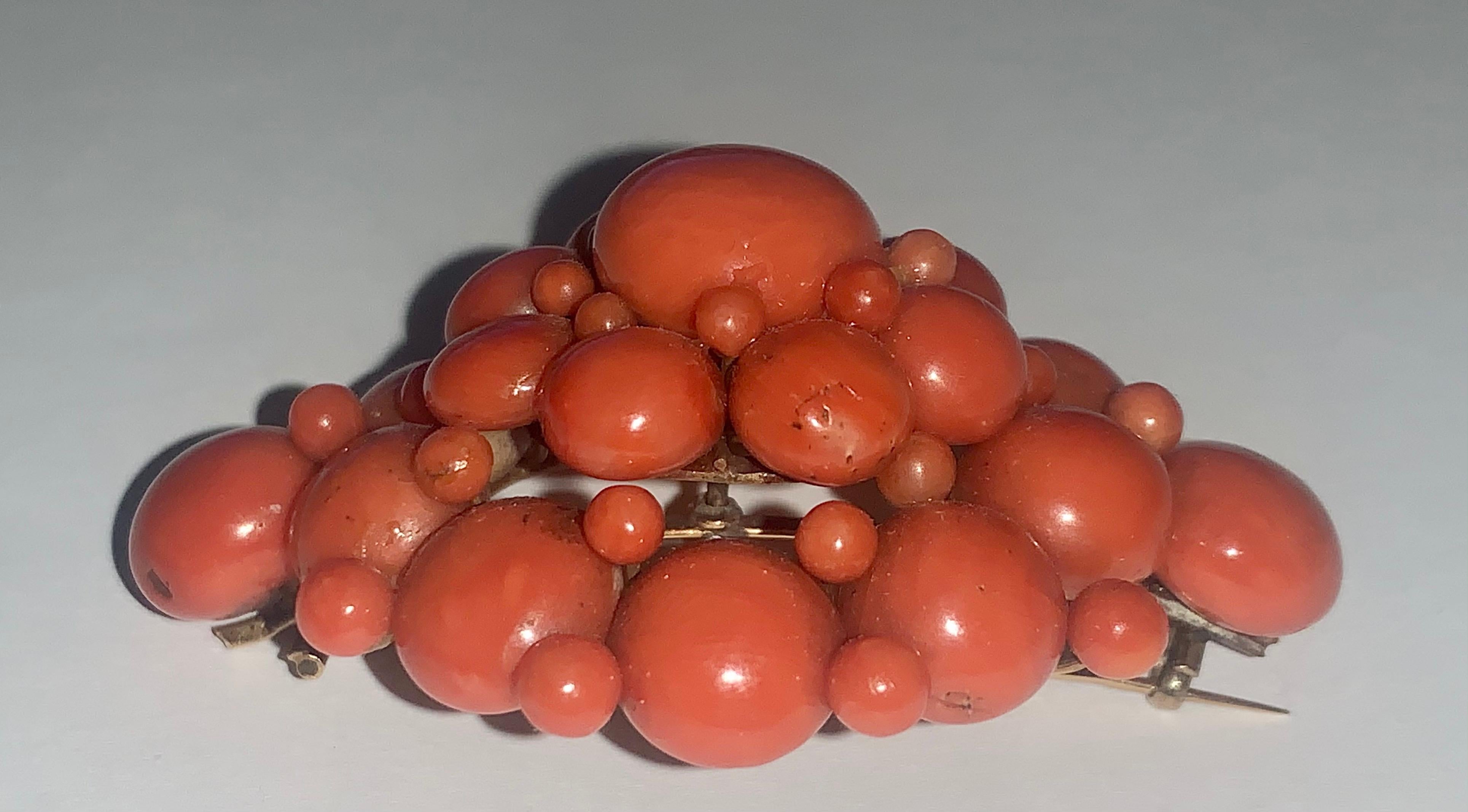 Beautiful large statement piece brooch from the late Victorian period consisting of 6 tiers of natural Mediterranean salmon coral beads with sizes ranging from 12mm to 4mm attached to a 15k gold backing. There are no missing beads in excellent