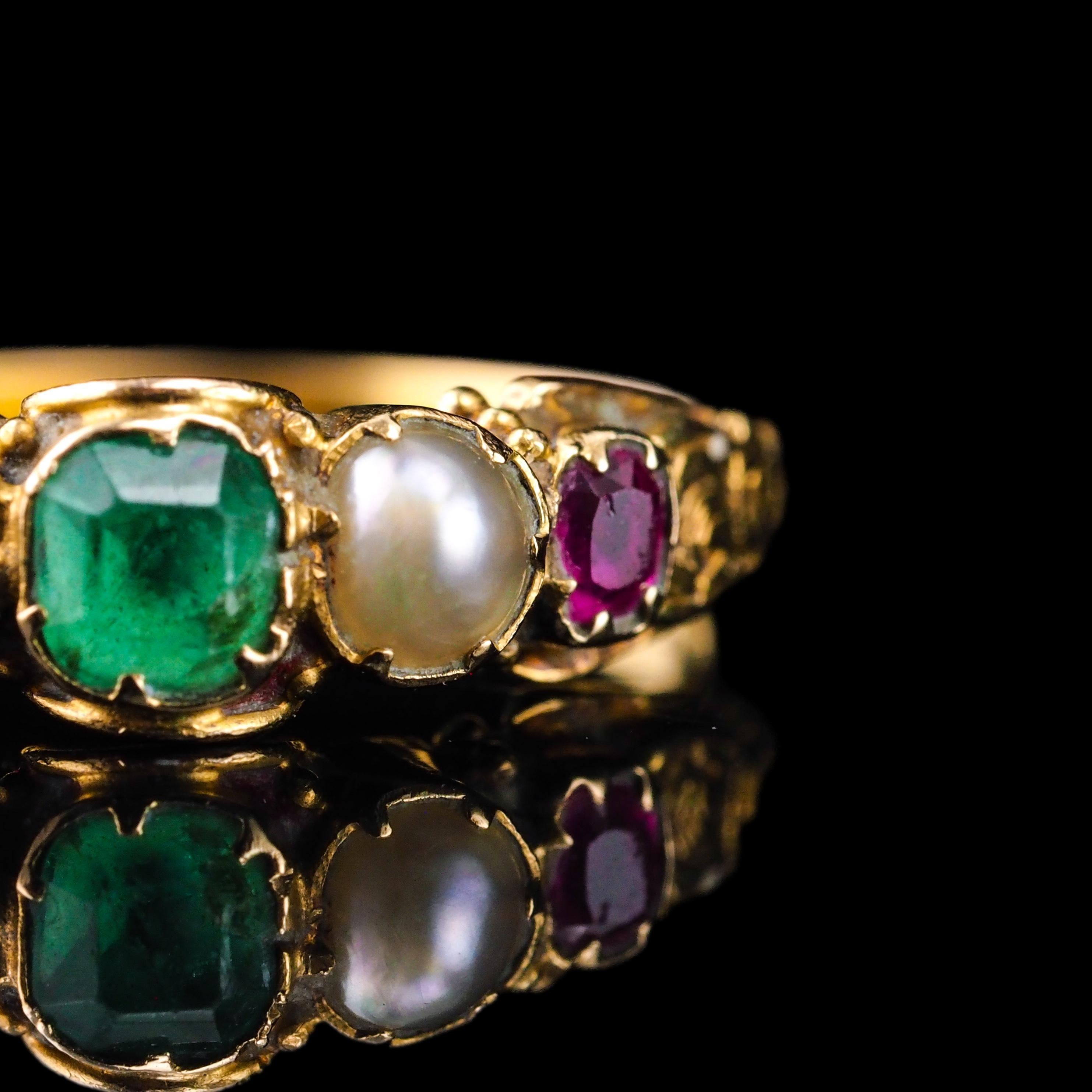 We are delighted to offer this enchanting antique 15ct gold emerald, garnet and pearl ring made in the Victorian era c.1880.

The ring presents a suffragette theme with one central emerald flanked by the other gemstones which not only are symbolic