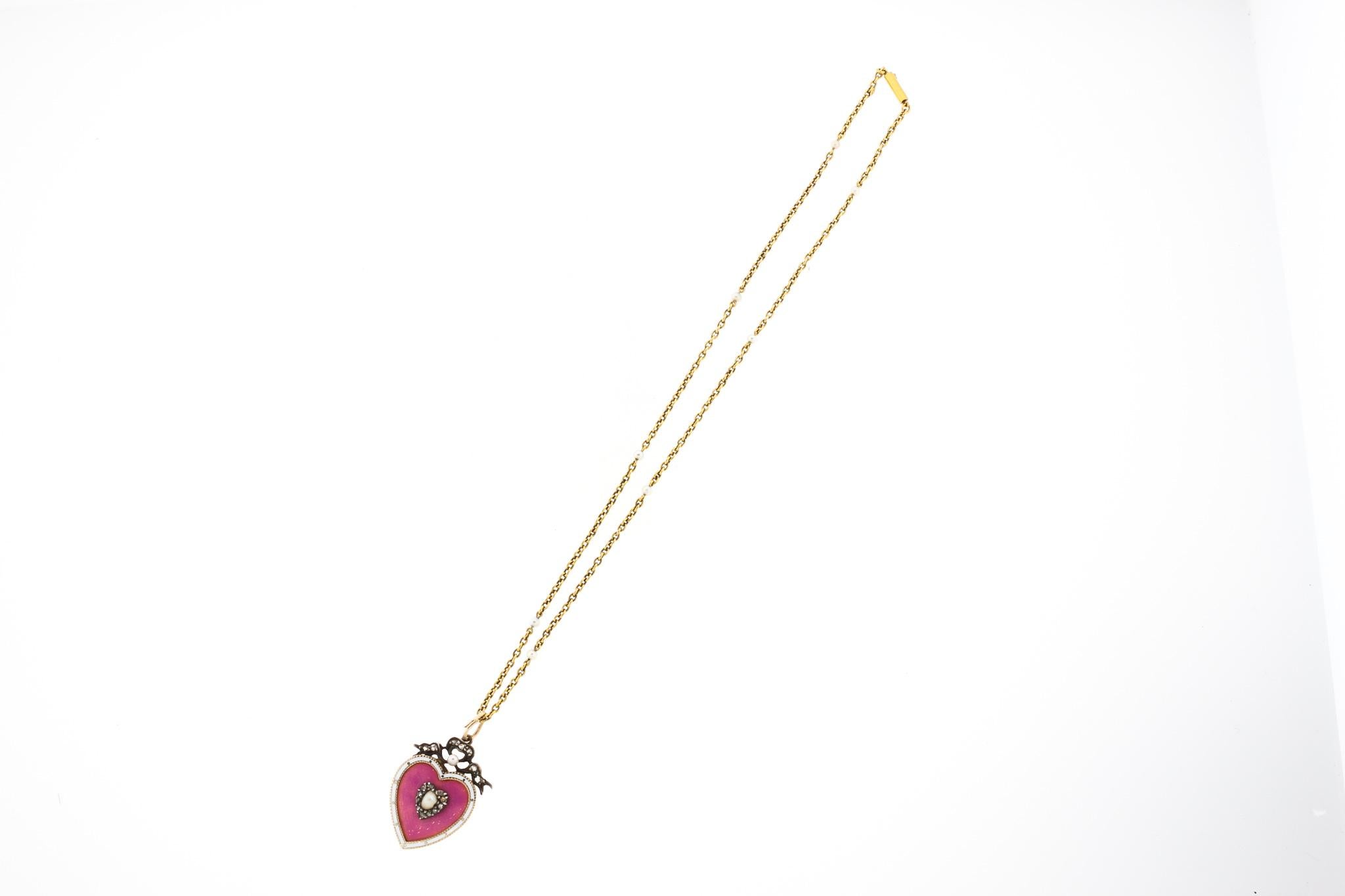Antique Victorian pink enamel heart pendant suspended from its original 15k gold chain with small seed pearls, circa 1880. This necklace is such a sweet jewel, especially hanging from its original antique chain. It was likely made in England. The