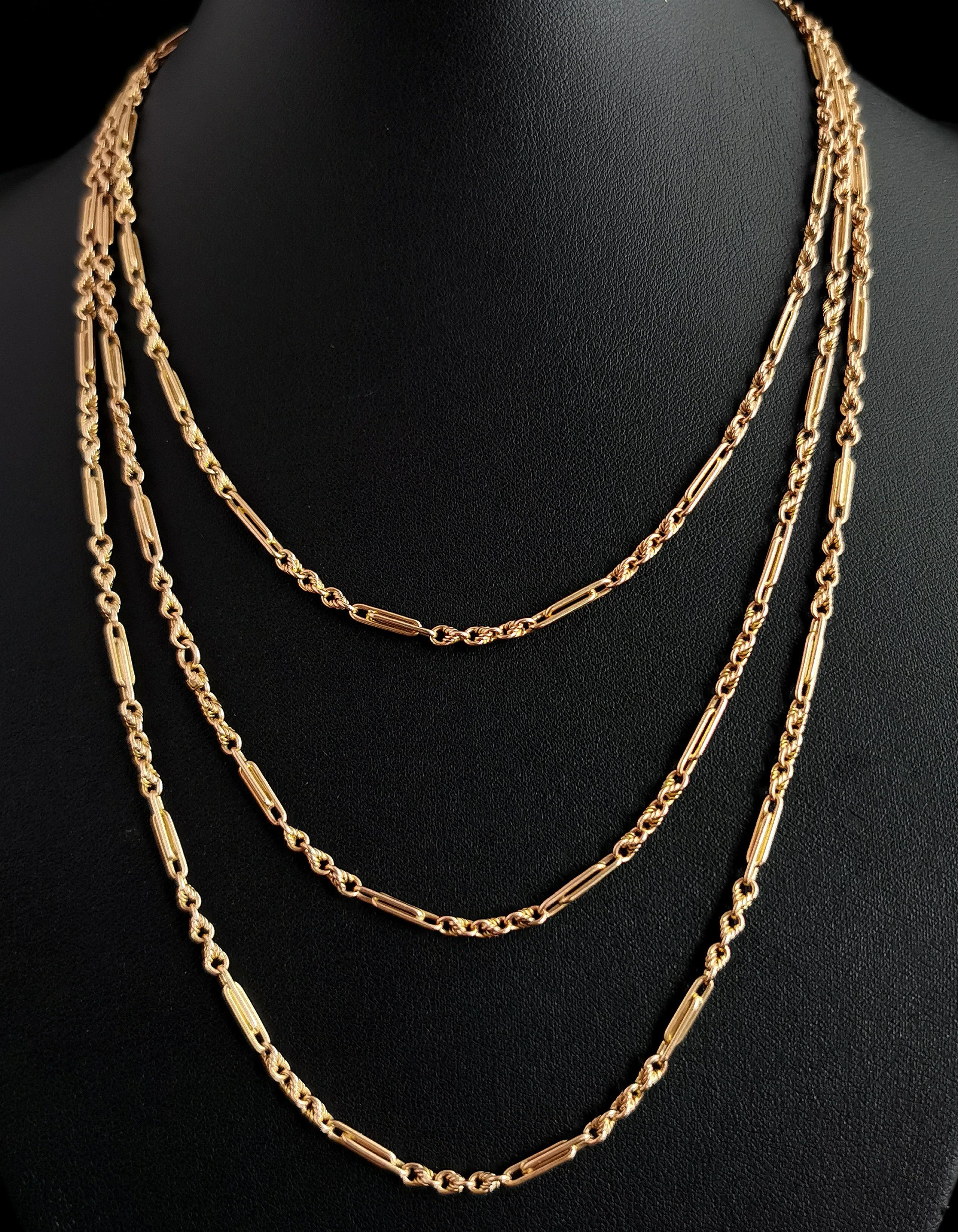 An impeccable antique, late Victorian era 15kt gold longuard chain necklace.

The lush, rich 15kt gold is warm and and inviting with a hue that is highly sought after in addition to the well designed paperclip and knot links and will make a