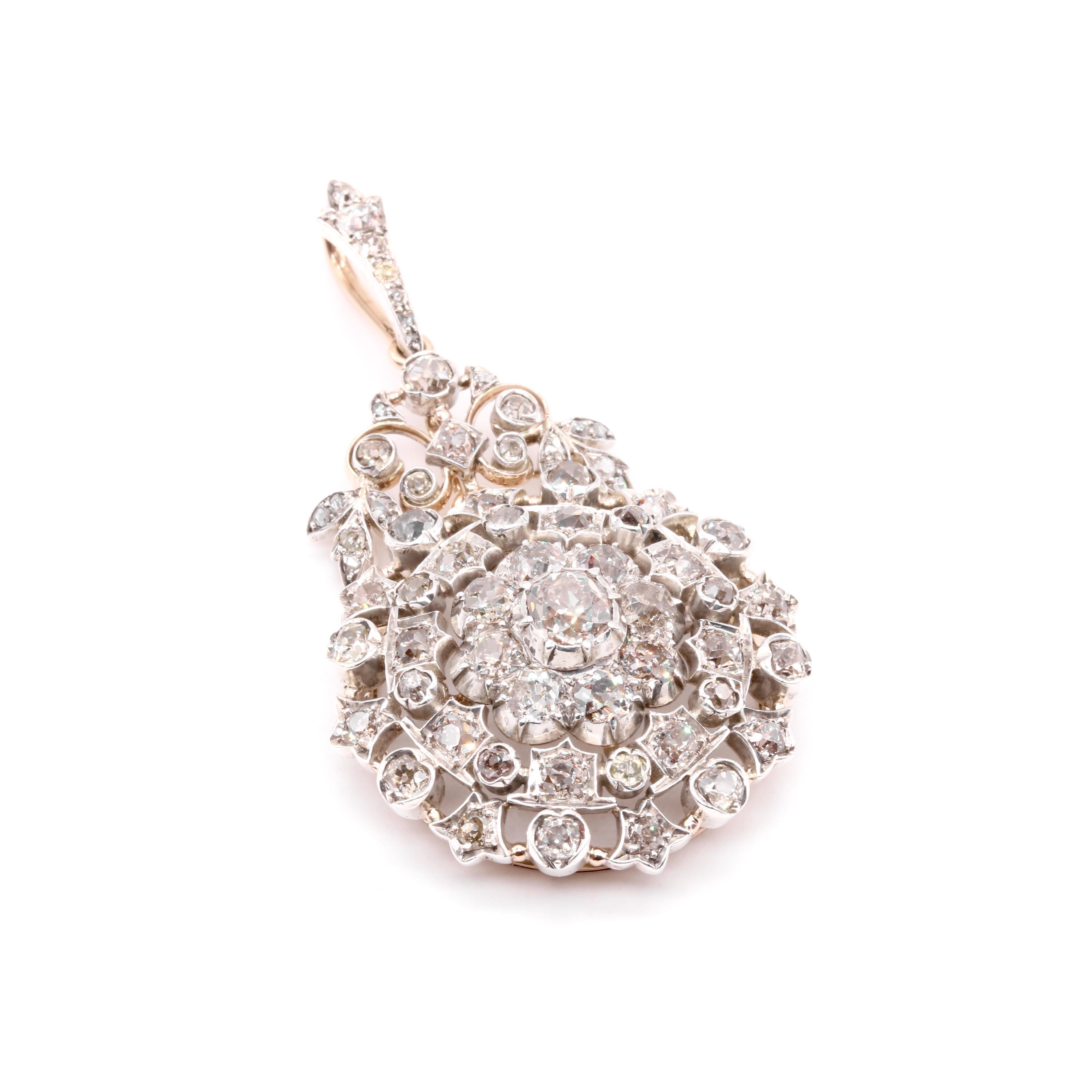 A Victorian diamond, silver, and yellow gold brooch and pendant, comprising one large old mine cut diamond, fifty-two smaller old mine cut diamonds, and fifteen rose cut diamonds, set in silver, and backed in 15 karat yellow gold, with detachable