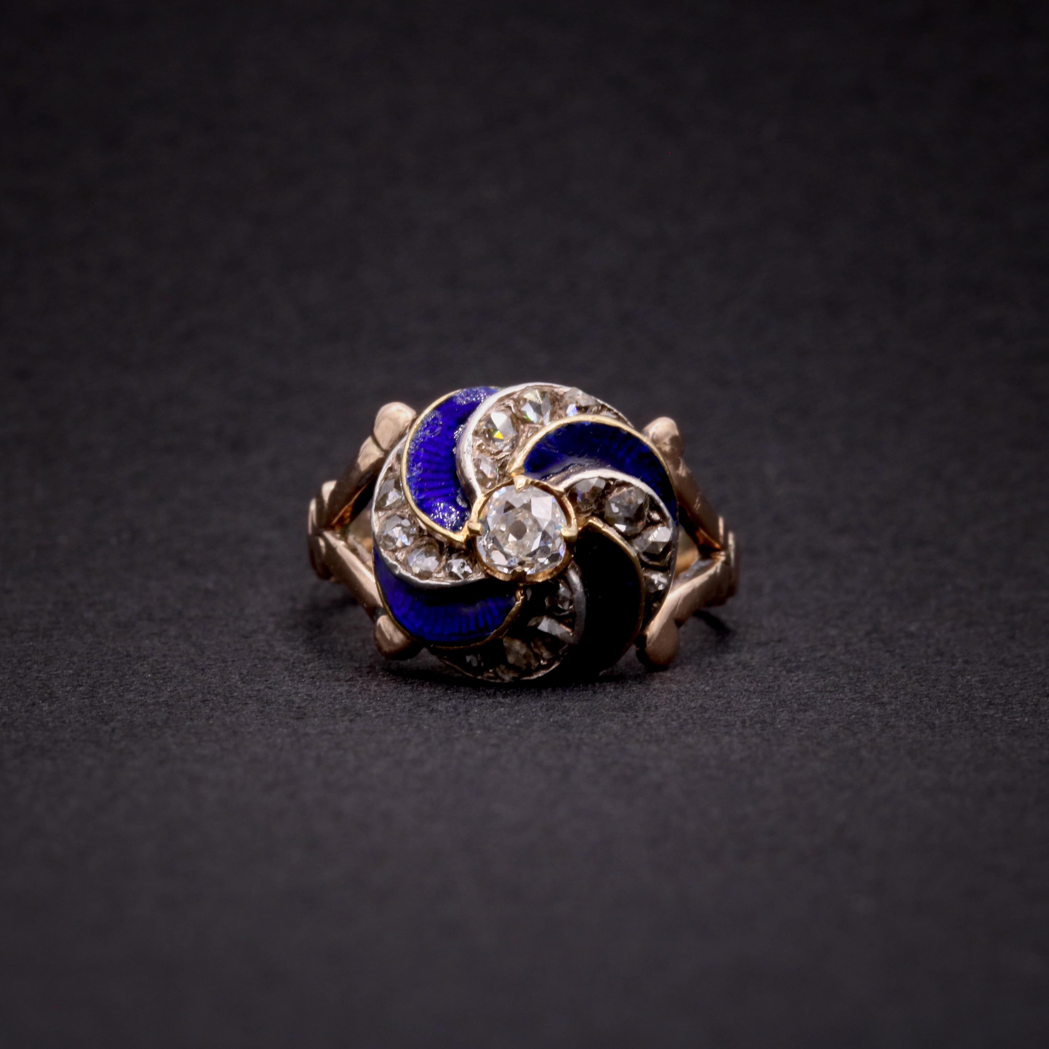 A Victorian diamond, enamel, silver, and yellow gold ring, comprising one old mine cut diamond, twenty rose cut diamonds, and blue enamel, set in silver and 15 karat yellow gold, to a 15 yellow gold band. 

This Victorian ring centres around a large