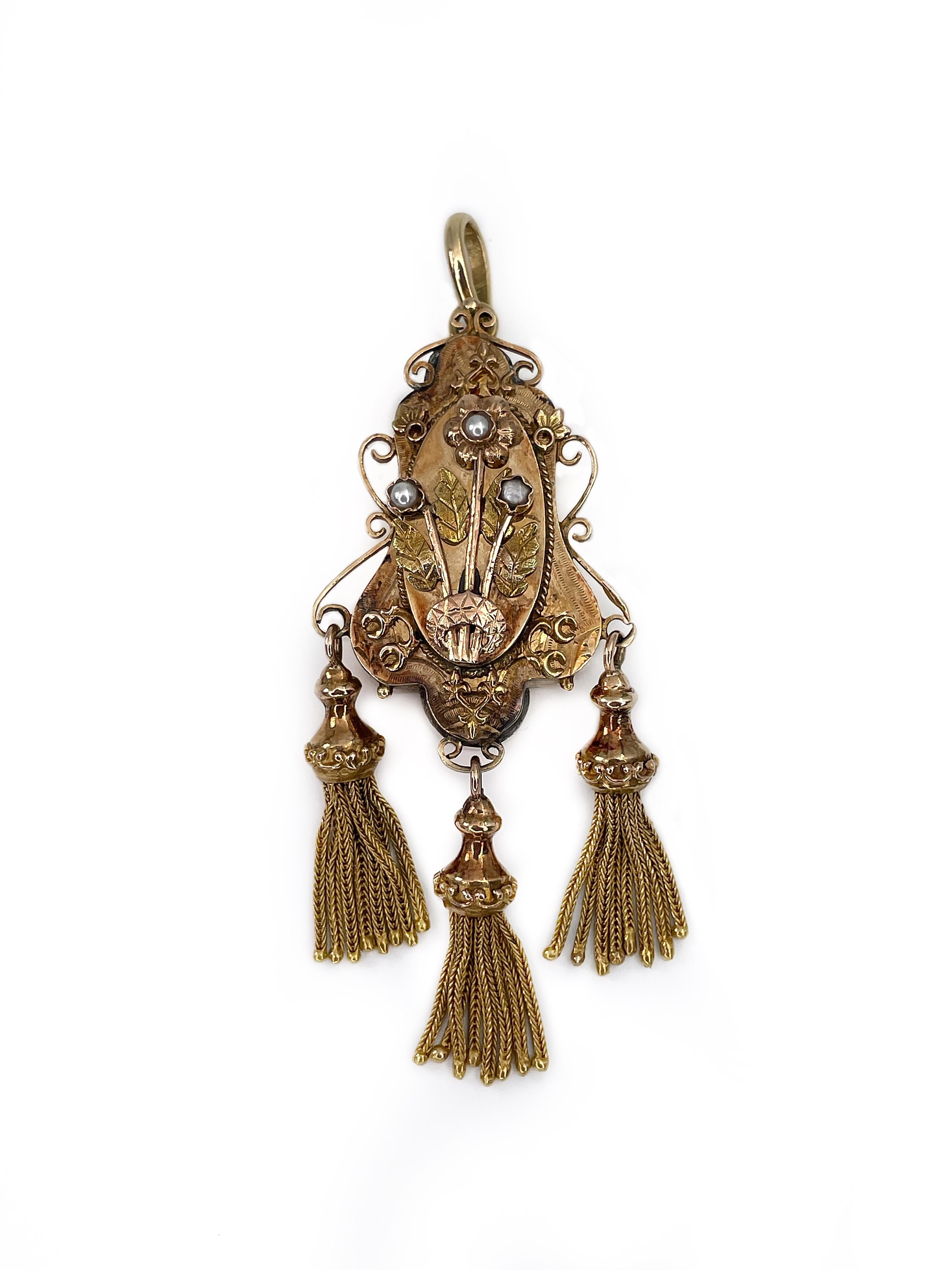 It is a stunning Victorian pendant crafted in 15K yellow gold. It features three seed pearls incorporated into a romantic and rich floral design. The piece is dynamic because of charming tassels. 

Weight: 12.41g
Size: 7x2.5cm