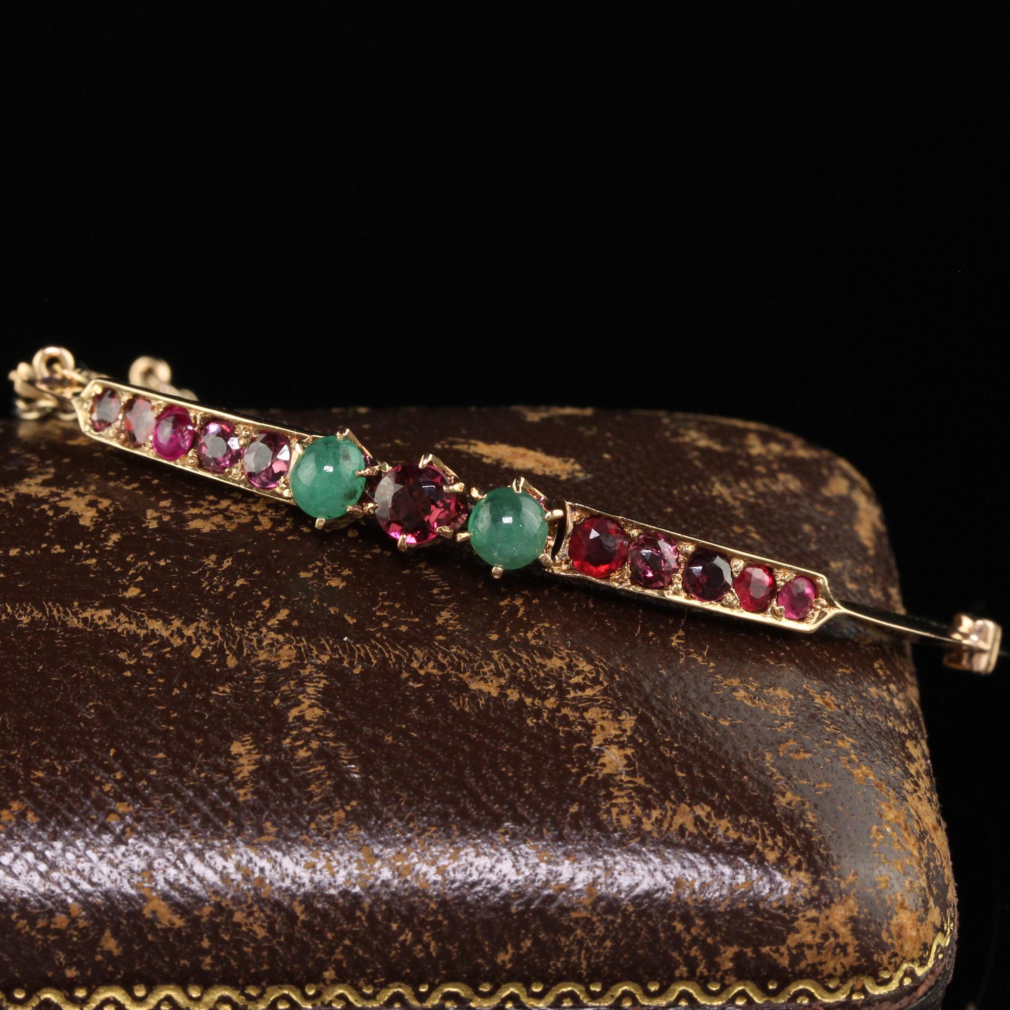 Beautiful Antique Victorian 15K Yellow Gold Garnet and Emerald Bangle Bracelet. This beautiful Victorian bangle bracelet is crafted in 15k yellow gold. The bangle has old cut garnets and two cabochon emeralds set on top of the bangle. The band of