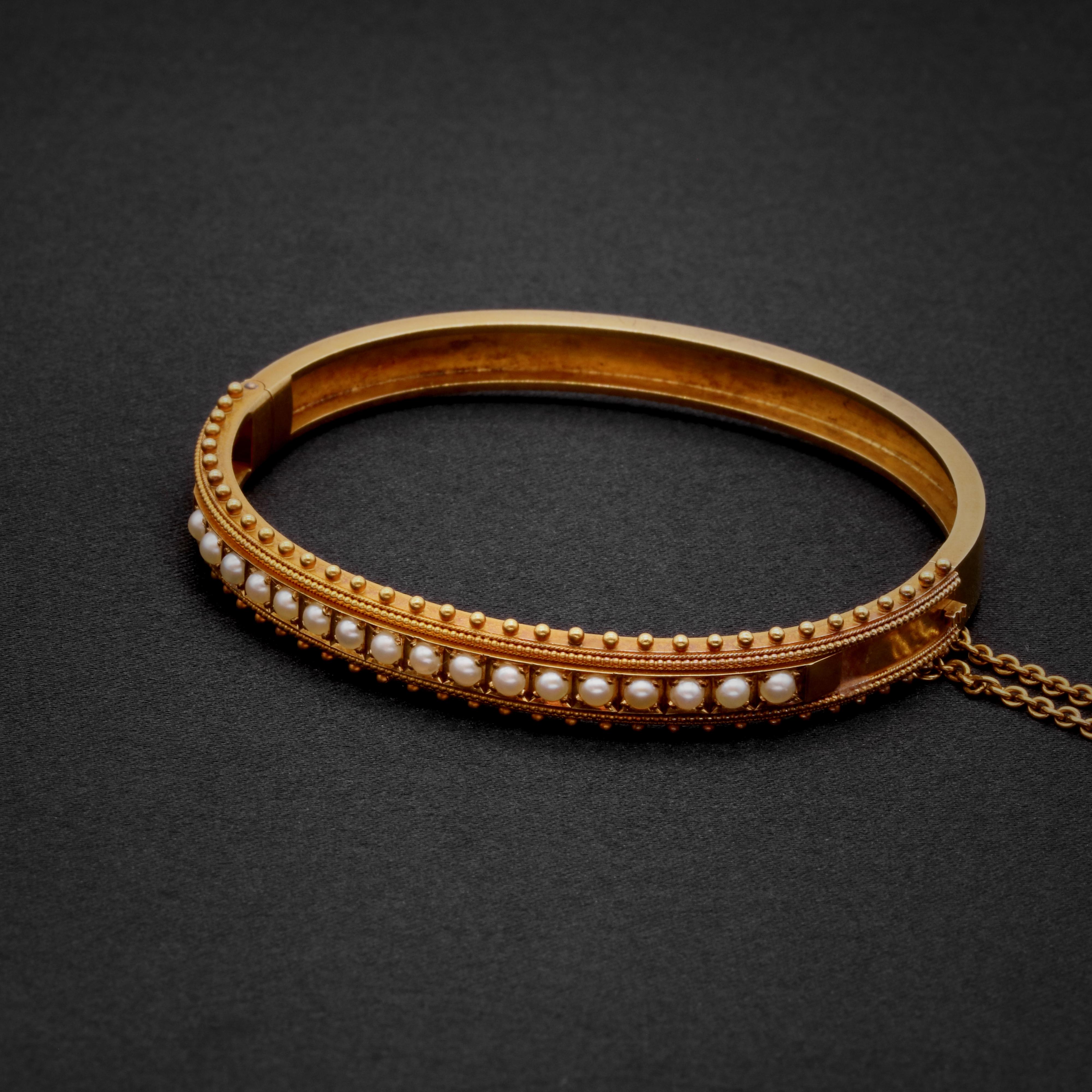 A Victorian pearl, and yellow gold bangle, comprising seventeen half seed pearls, in 15 karat yellow gold. 

This magnificent Victorian bracelet is set with shimmering half seed pearls, which are held within square settings. The pearls are pale,