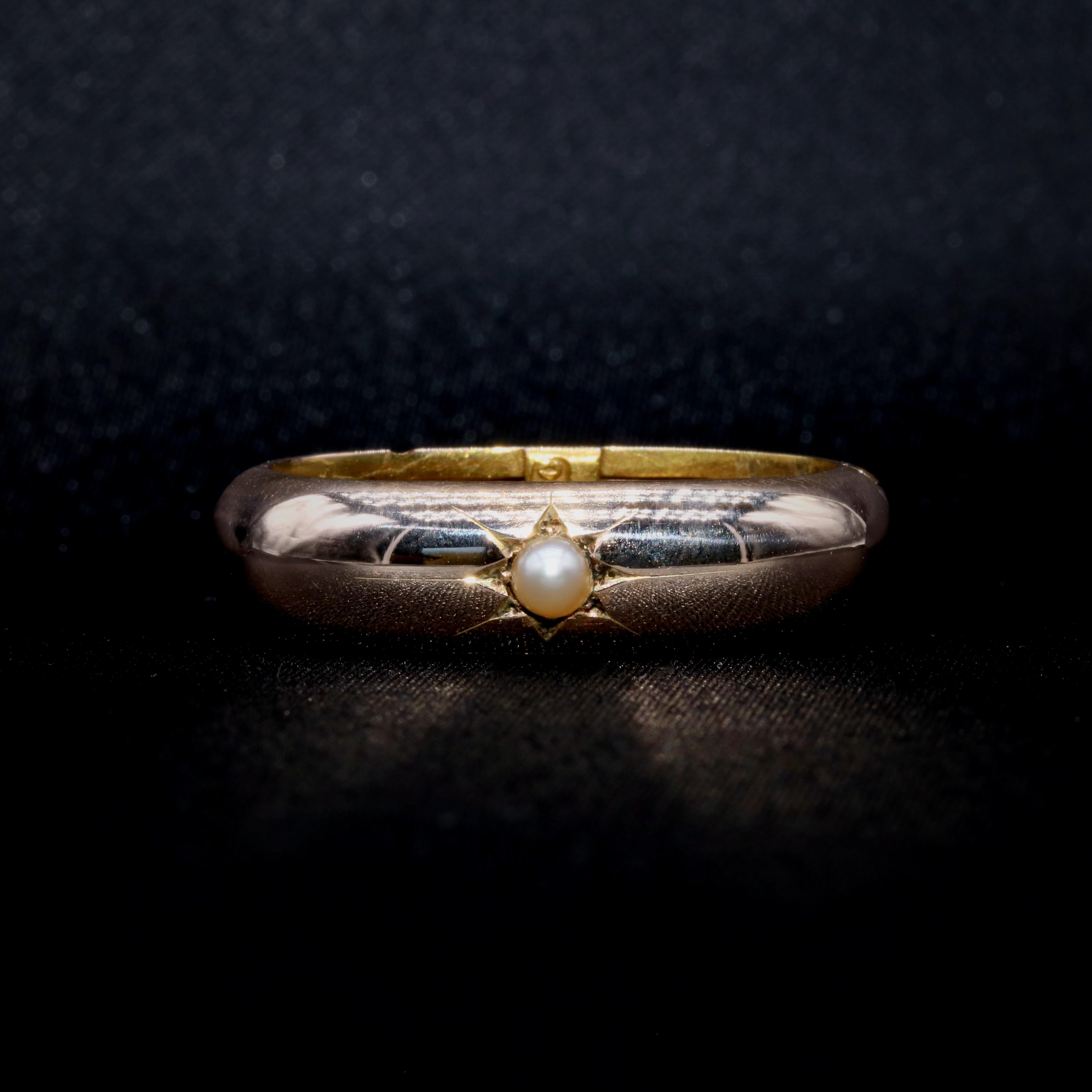 A Victorian yellow gold and pearl scarf clip, comprising one round half seed pearl, set in 15 karat yellow gold. 

This lovely scarf clip is set to the centre with a shimmering seed pearl. The seed pearl is pale, shimmering, and lustrous, and set