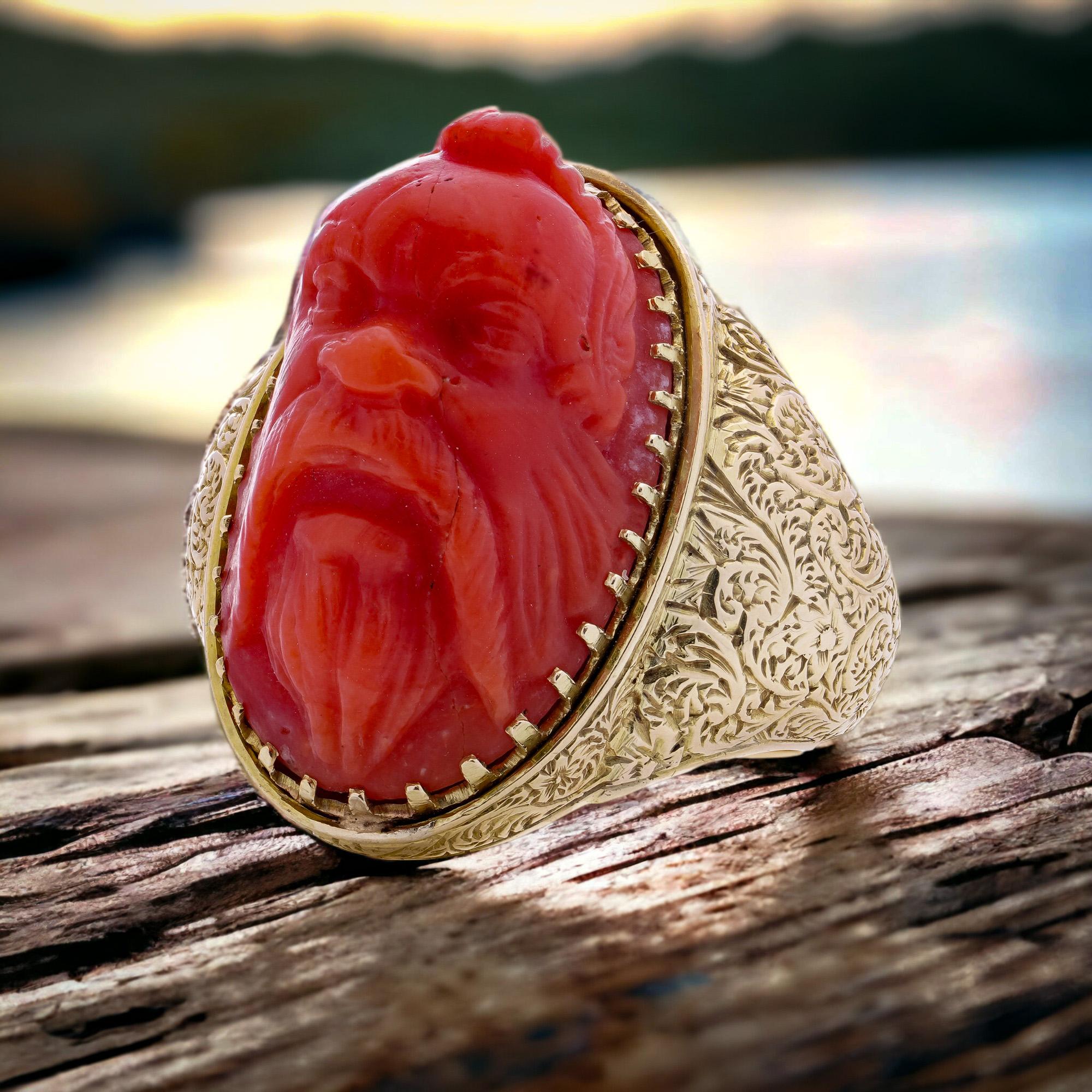Antique Victorian 15kt. yellow gold coral ring, featuring a carved river God's head. 
Made in England, 1871 
Fully hallmarked.

The dimensions - 
Ring Size: Length x Width x depth: 3.5 x 3 x 1.2 cm 
Finger Size (UK) = T (EU) =61 (US) = 10 
Weight: