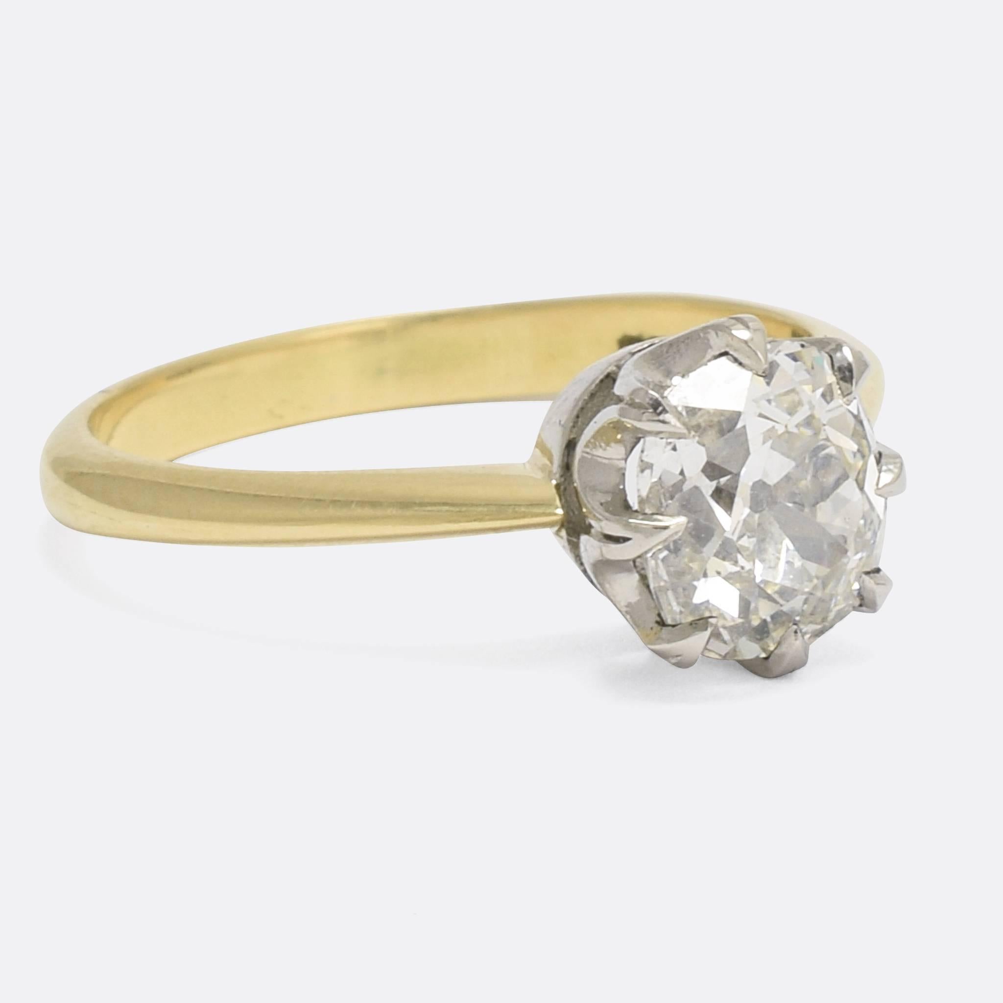 A stunning antique engagement ring set with a beautiful antique cushion cut diamond in a classic eight-claw mount. The stone is 1.69 carats in weight, and grades at G colour with VS1 clarity. Modelled in 18 karat gold with a platinum head, it would