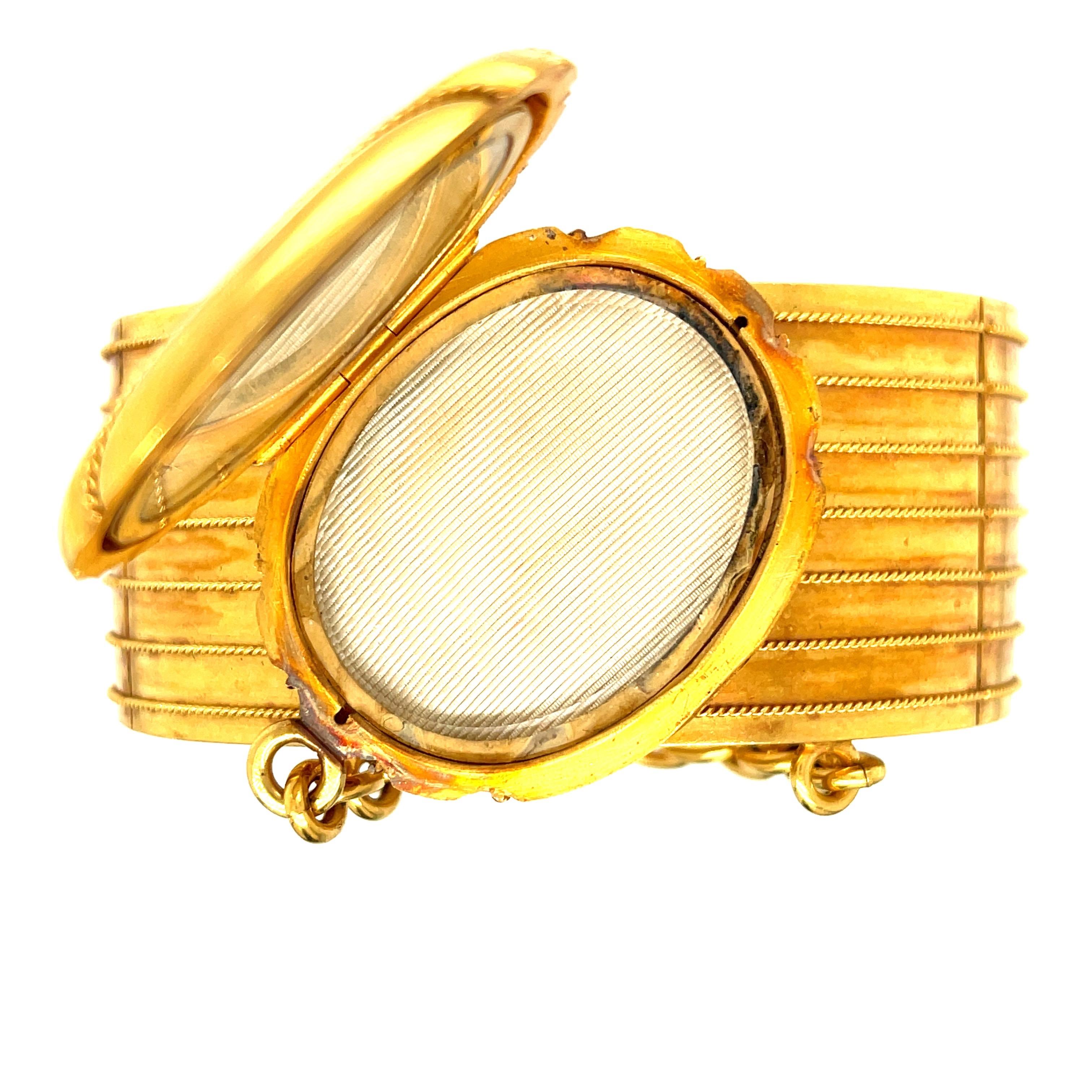 A rare example of a Victorian bangle bracelet with an attached locket, circa 1880. This bracelet is so unusual in its design, but combines two very Victorian loves - gold bangle bracelets and lockets. This wide bangle is made in 18k gold and has