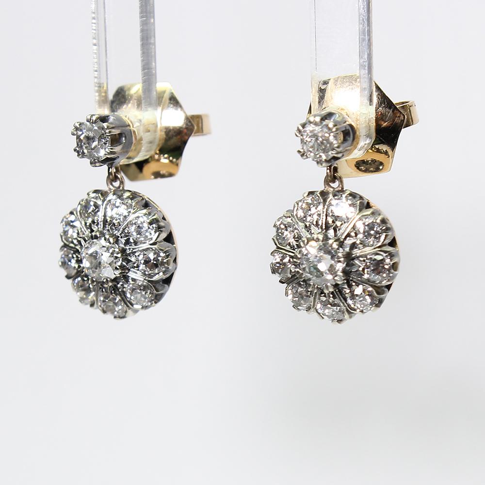 Period: Victorian (1836-1901)
Composition: 18K gold and silver.

Stones:
•	2 Old mine cut diamonds of H-VS2 quality that weigh 0.60ctw. (0.30ctw. each).
•	20 Old mine cut diamonds of H-VS2 quality that weigh 1.80ctw. 
Earring measures: 18mm by 11mm