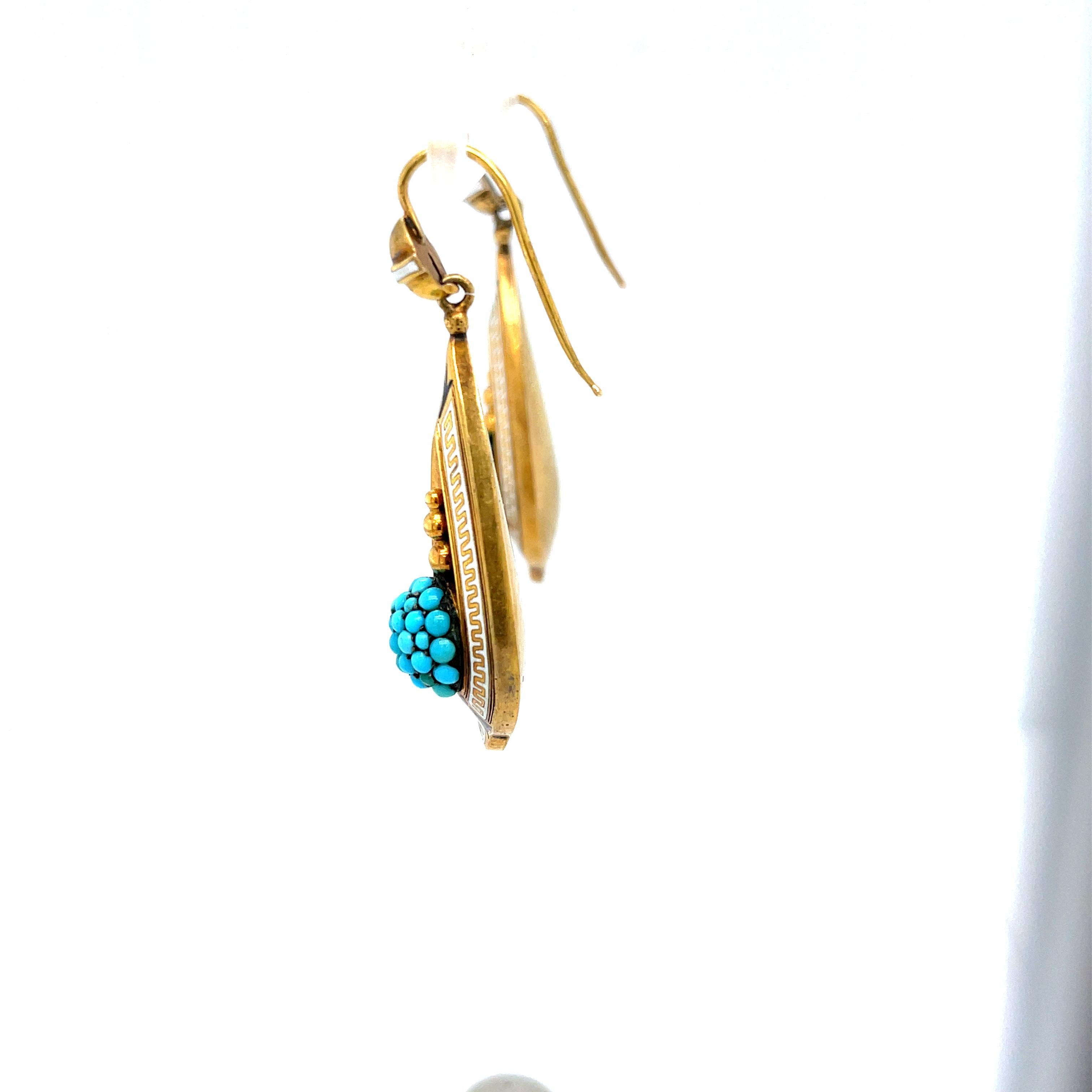 Antique hollow form 18k yellow gold dart shaped ear pendants with turquoise and enamel, circa 1880. These earrings have wonderful dimension and shape. The turquoise ball part is well done and the Greek key white enamel around the edges is a true