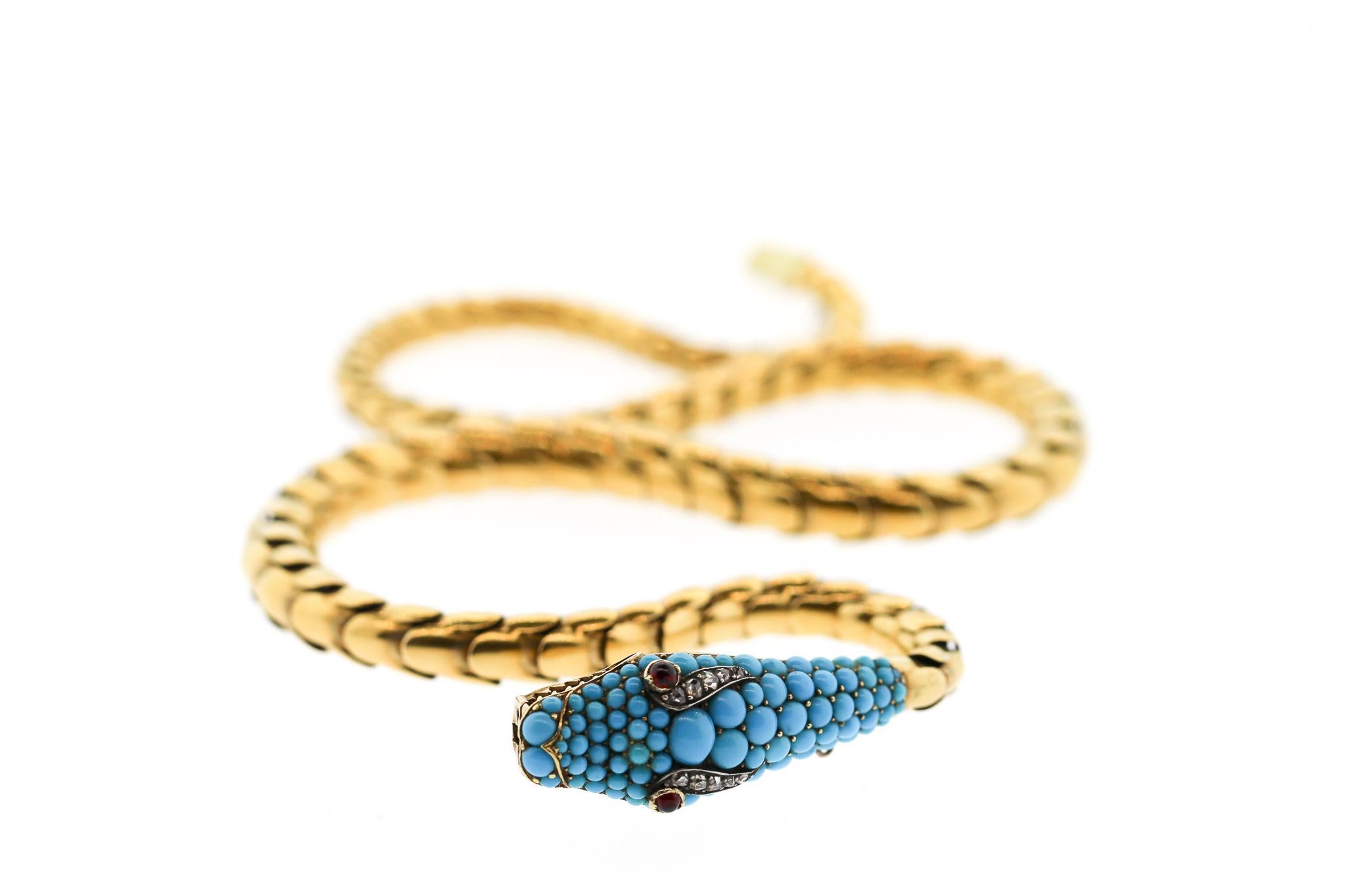 A Victorian gold snake necklace with a pave turquoise head biting its tail, circa 1880. The snake symbolizes everlasting love, rebirth and fidelity in the Victorian times. When Prince Albert gave Queen Victoria a snake ring, a craze for snake
