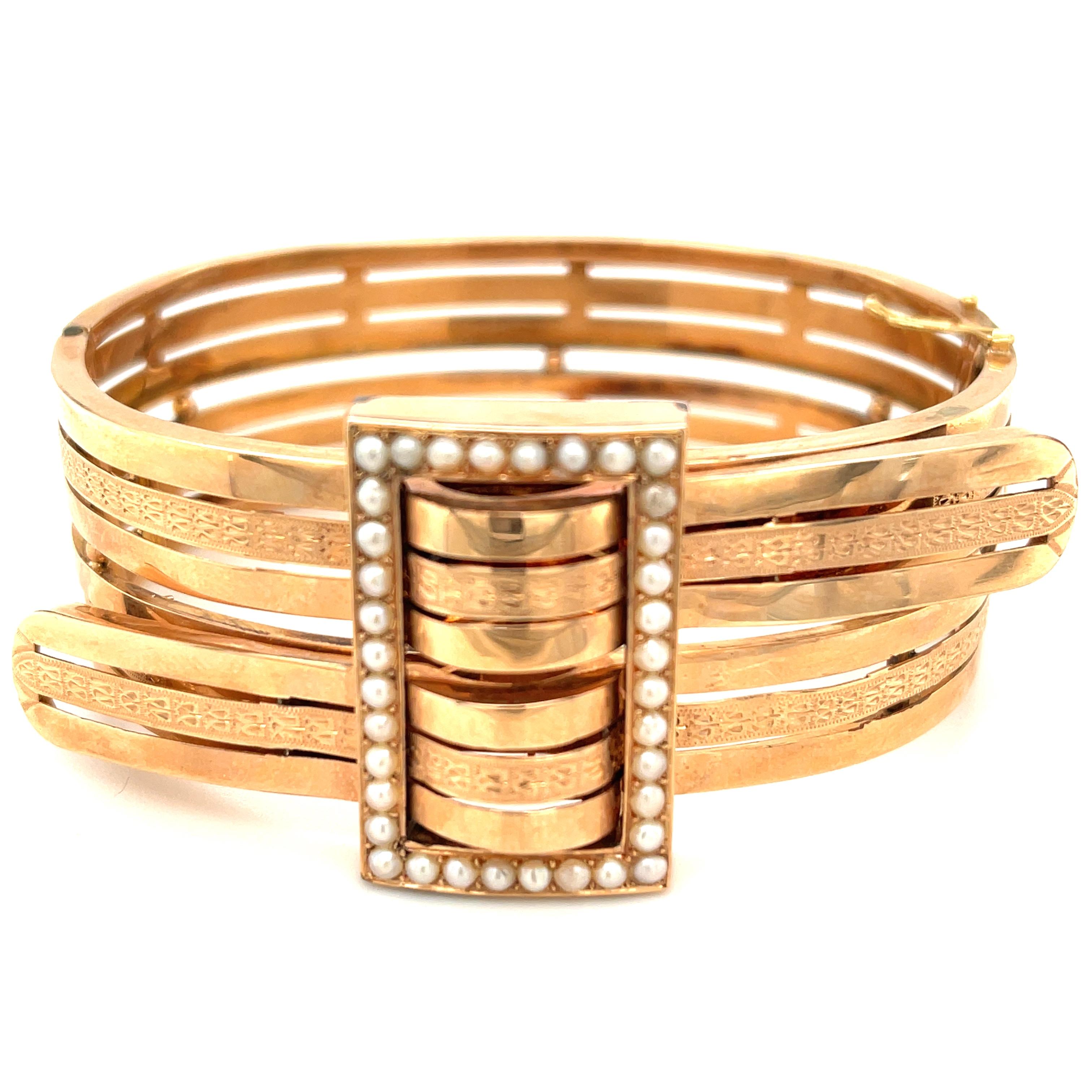A lovely 18k rose gold Victorian bypass bangle bracelet set of a buckle design set with pearls circa 1890. Designed as two gold ribbons with engraving woven through a buckle that is set with split pearls. A very sentimental and Victorian design. The