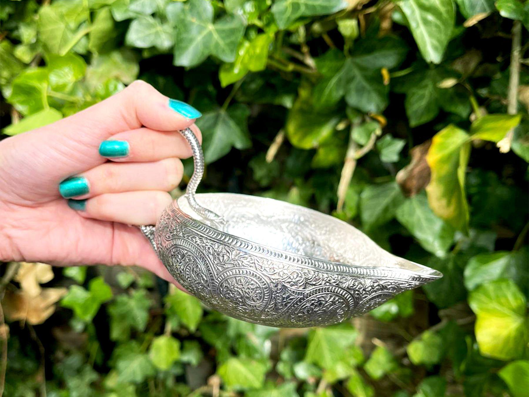 An exceptional, fine and impressive antique Victorian English sterling silver cream jug; an addition to our silver teaware collection.

This exceptional antique Victorian sterling silver cream jug has a compressed, circular rounded form.

The