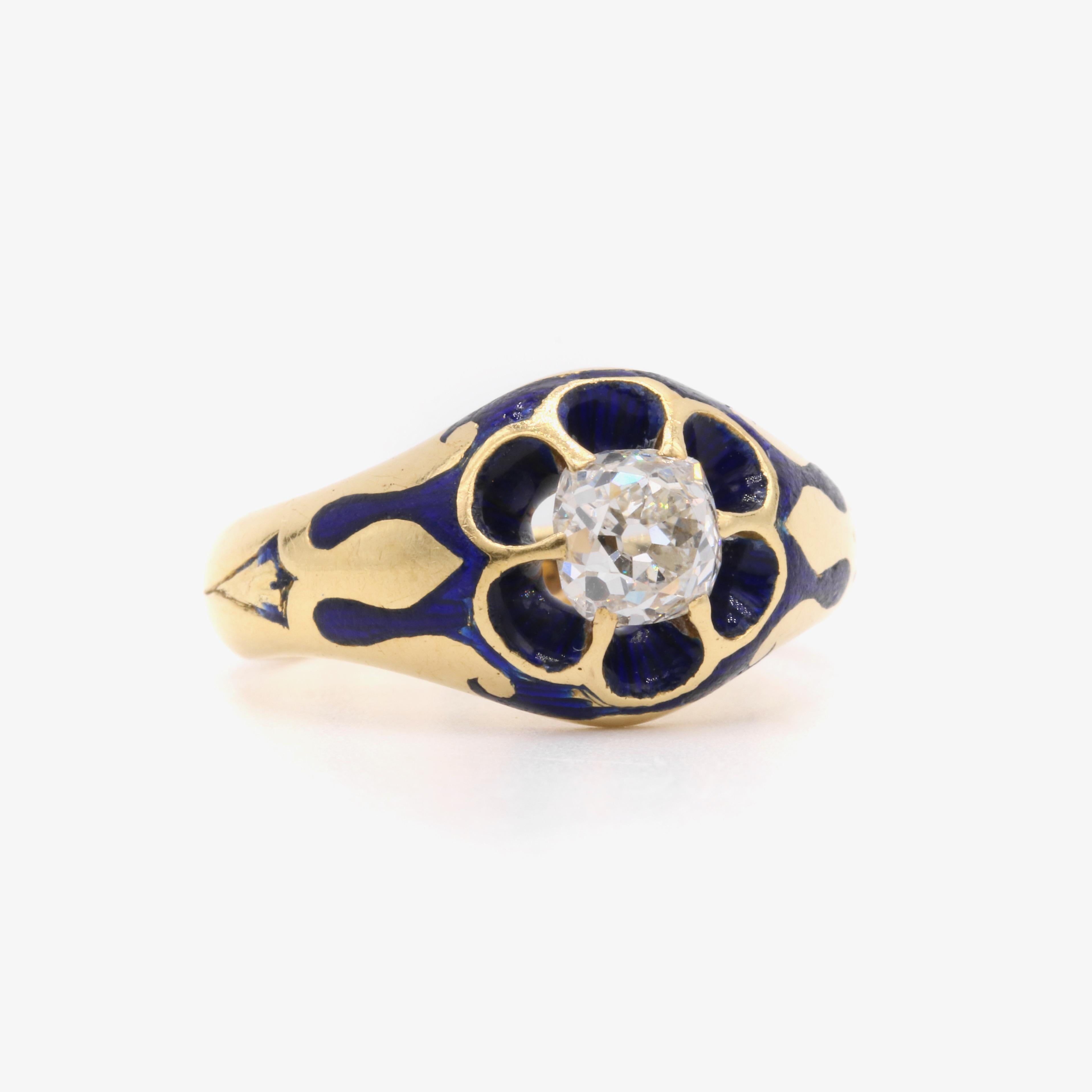 An antique yellow gold, enamel, and diamond ring, comprising one large old mine cut diamond and blue enamel decoration, set in 18 karat yellow gold, to a band of 18 karat yellow gold.

This striking ring is unlike any other ring I have come across,