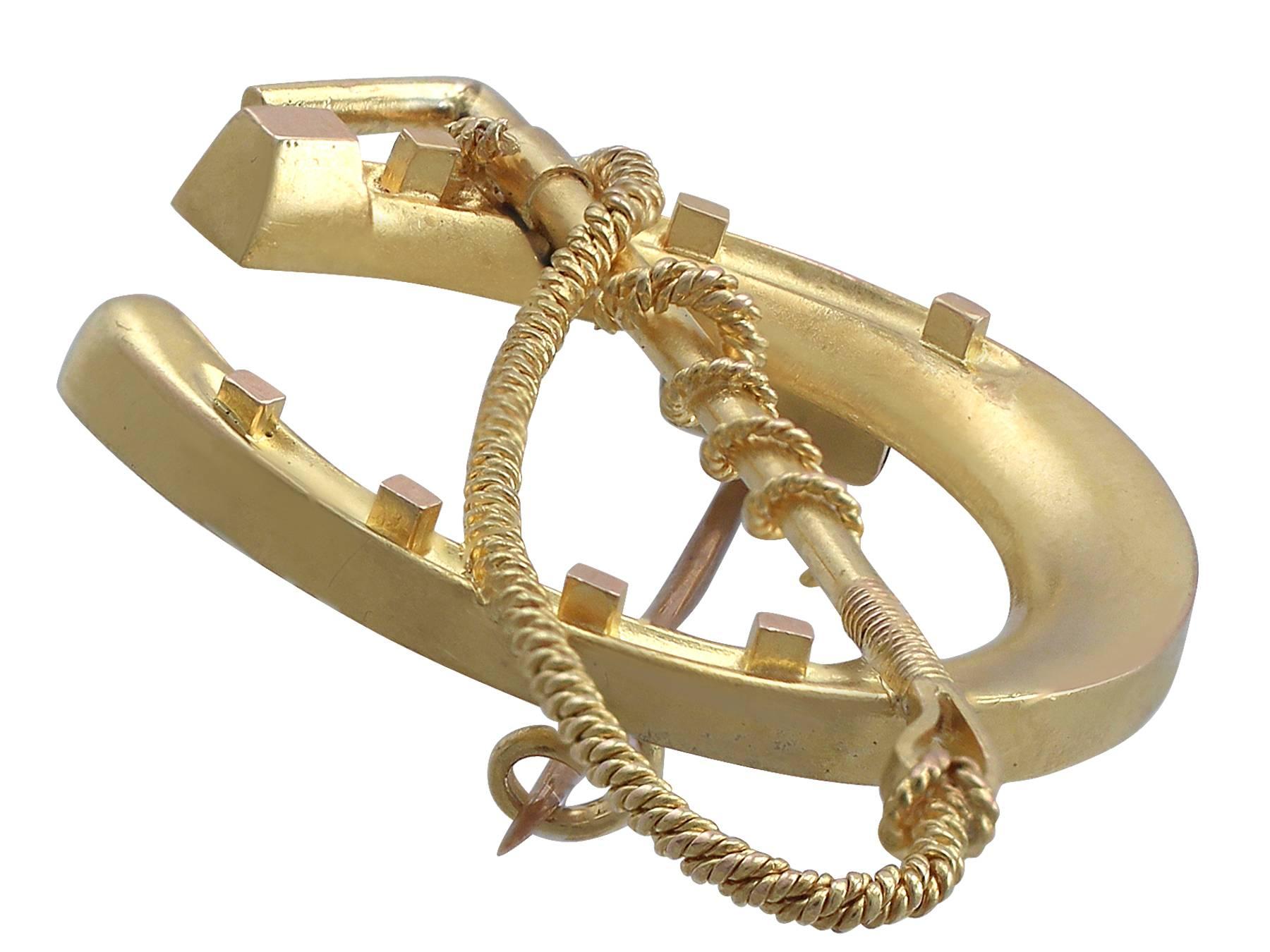 An impressive antique Victorian 15 karat yellow gold 'horseshoe and crop' brooch; part of our diverse antique jewelry and estate jewelry collections

This fine and impressive antique horseshoe brooch has been crafted in 15k yellow gold.

The brooch