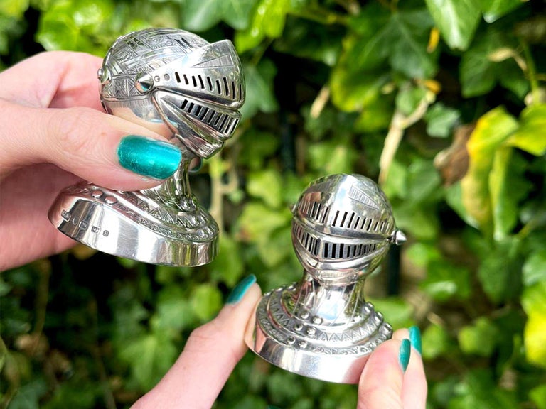 An exceptional, fine and impressive, unusual pair of antique Victorian English sterling silver archaic knight helm/helmet peppers; an addition to our 19th century silver cruets/condiments collection.

These exceptional antique Victorian English