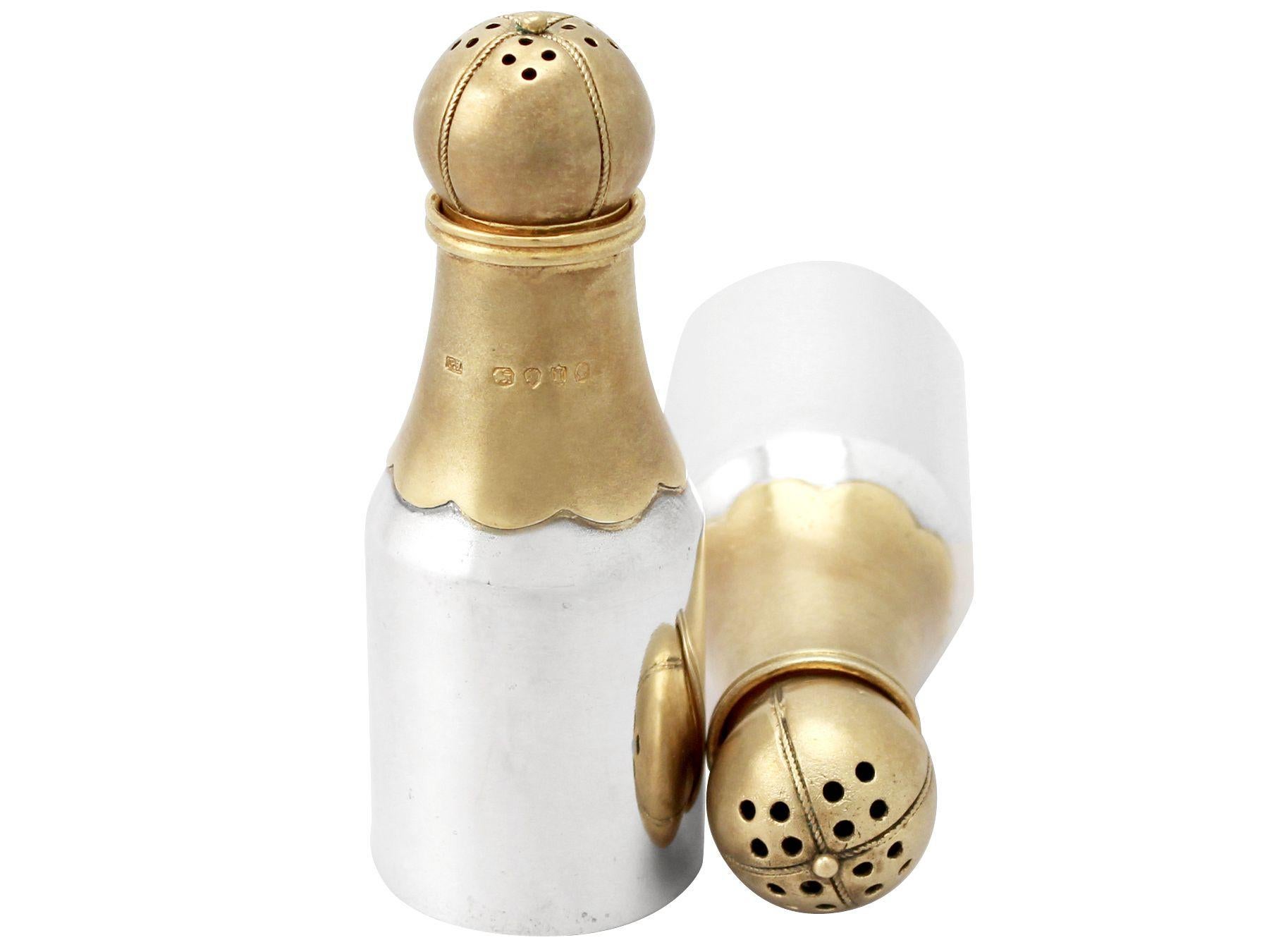 A fine and impressive pair of antique Victorian English sterling silver novelty pepper shakers in the form of champagne bottles; an addition to our silver cruets or condiments collection.

These impressive antique Victorian silver peppers, in