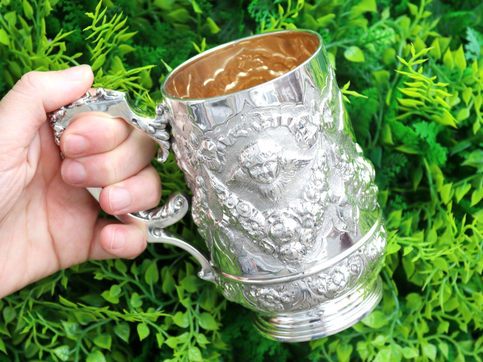 An exceptional, fine and impressive large antique Victorian English sterling silver christening mug; part of our silver christening collection

This antique Victorian silver christening mug has a circular, subtly tapering rounded form onto a