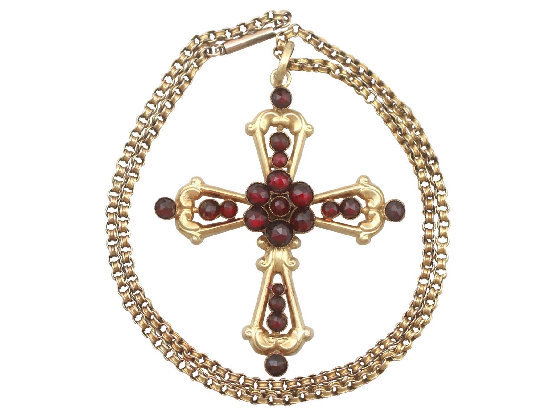 An impressive antique Victorian 5.56 carat garnet and 15 karat yellow gold cross pendant with a 9 karat yellow gold chain; part of our diverse antique jewelry and estate jewelry collections

This fine and impressive Victorian cross pendant has been