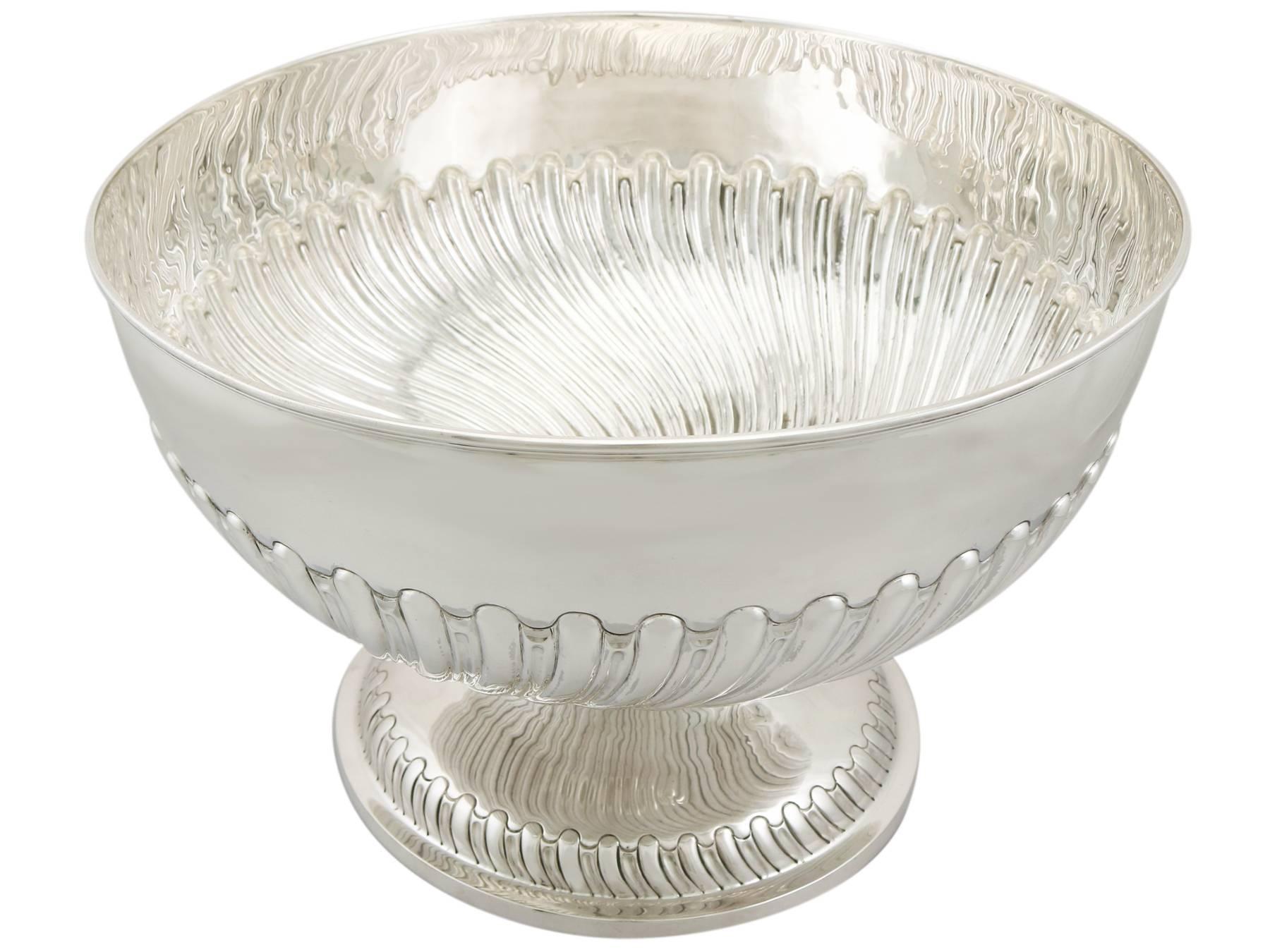 A magnificent, fine and impressive, large antique Victorian English sterling silver presentation bowl; an addition to our ornamental silverware collection.

This magnificent and large antique sterling silver presentation bowl has a plain rounded