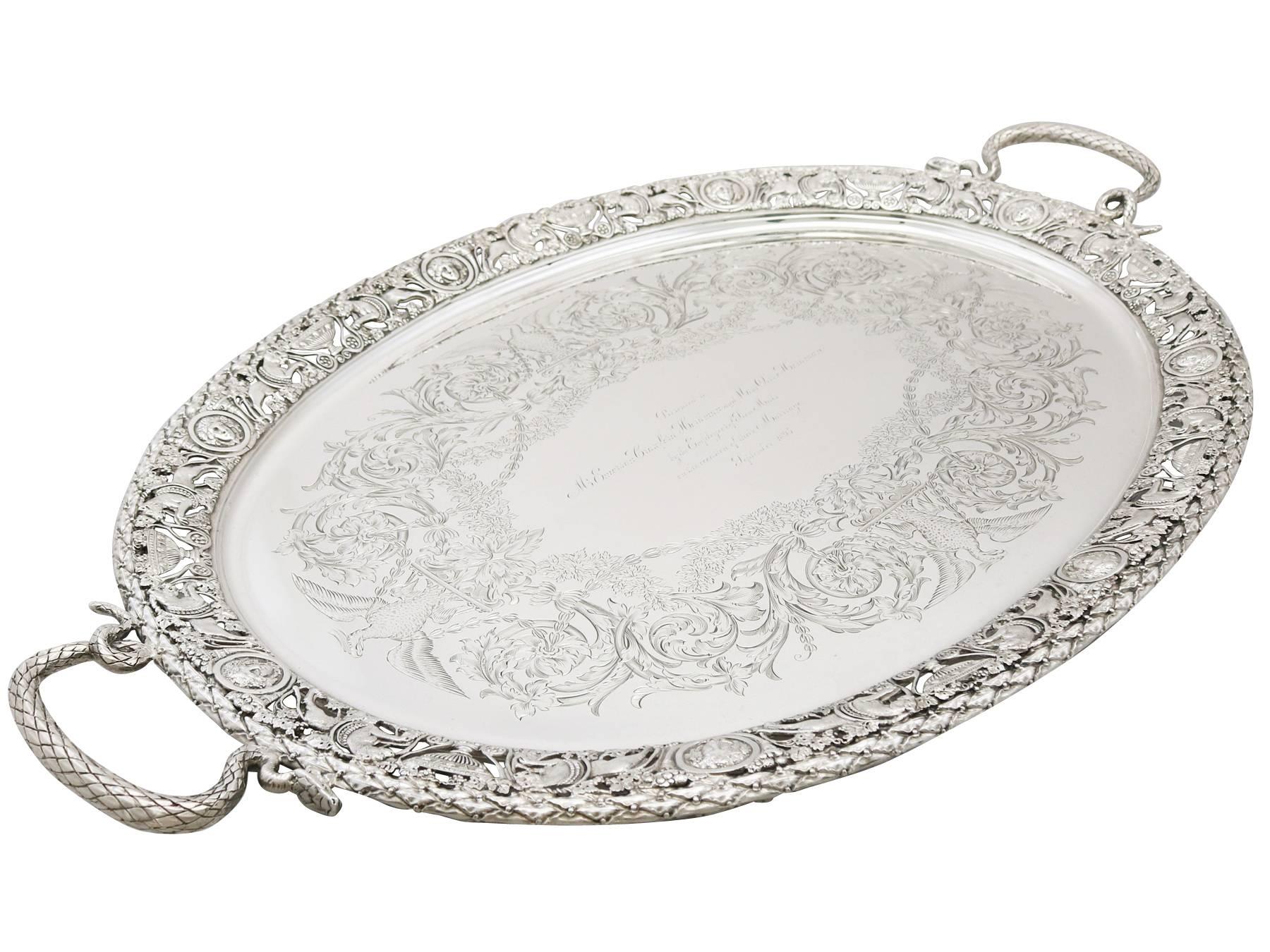 A magnificent, fine and impressive antique Victorian English sterling silver two handled tea tray; an addition to our silver tray collection.

This magnificent antique Victorian sterling silver tea tray has an oval shaped form.

The surface of
