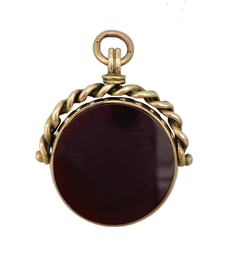 This swivel fob used to be worn on a watch chain. One side is set with a brown agate, the other with a bloodstone, also known as heliotrope. The swivel carries a makers mark, P.P.Co, a 9 karat hallmark for Birmingham and the year letter r for 1897.