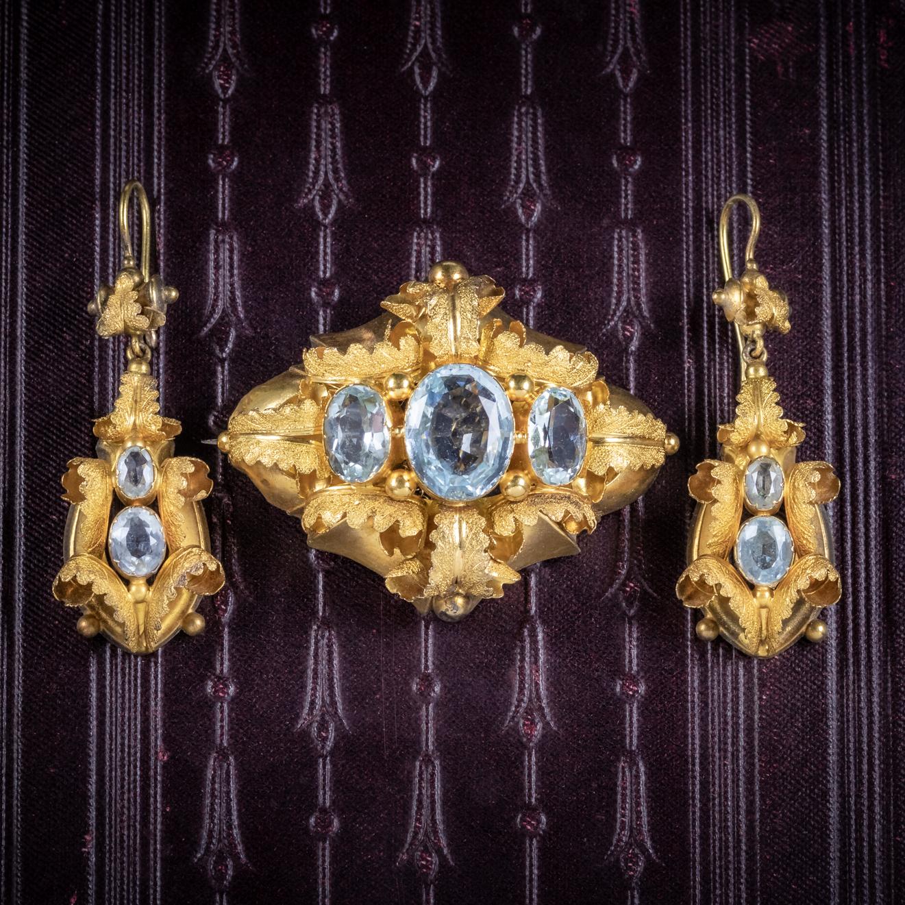 A stunning set of antique earrings and matching brooch from the Victorian era, Circa 1860. 

The brooch is adorned with three ocean blue Aquamarine’s set in a fabulous Cannetille gallery blossoming with Golden leaves. 

The central Aqua is approx.