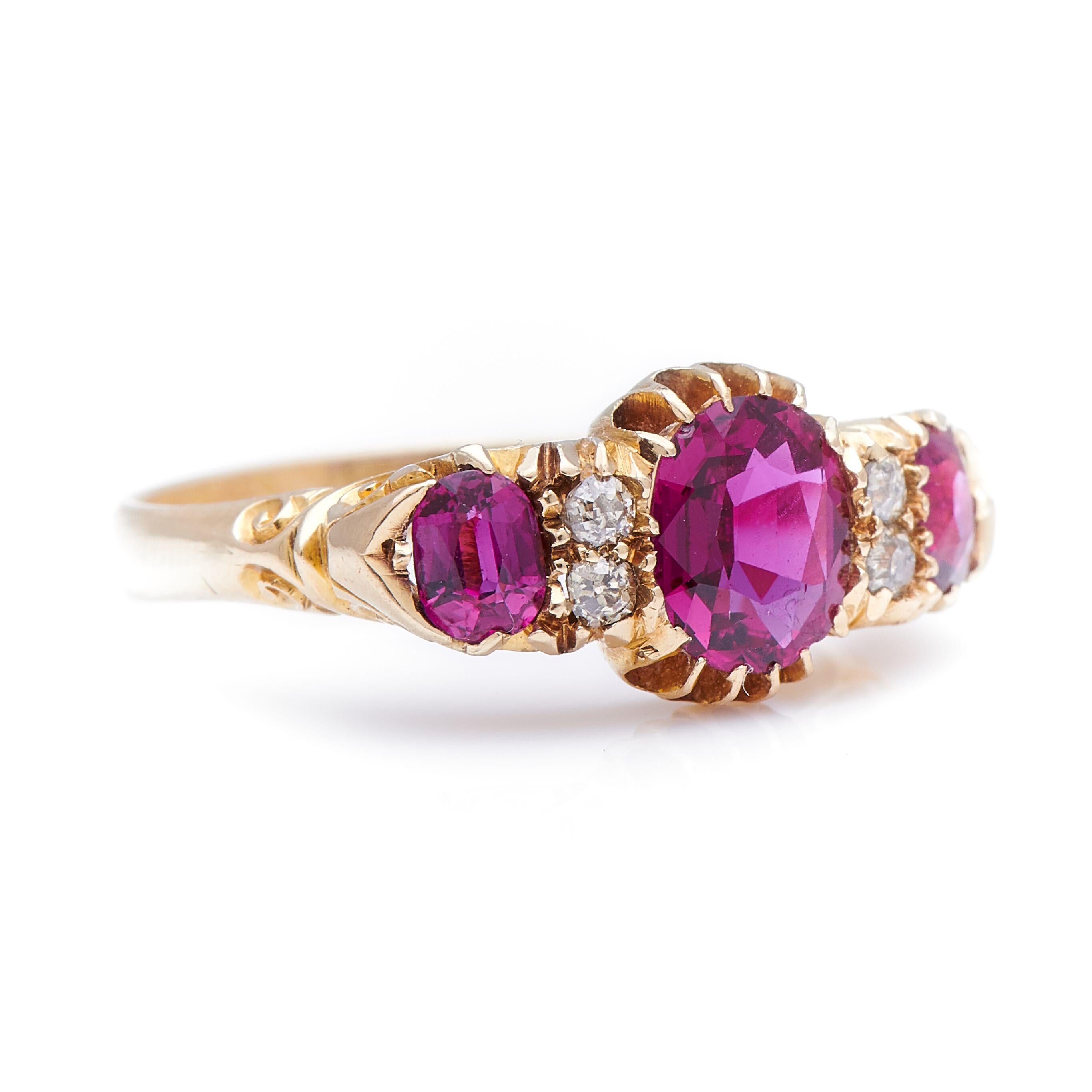Ruby and diamond ring, 1899. This ring is set with a trio of natural, untreated rubies with a deep, purplish body colour and excellent clarity, to a rich, buttery yellow gold mount enhanced with hand carved scrolled motifs and four single-cut