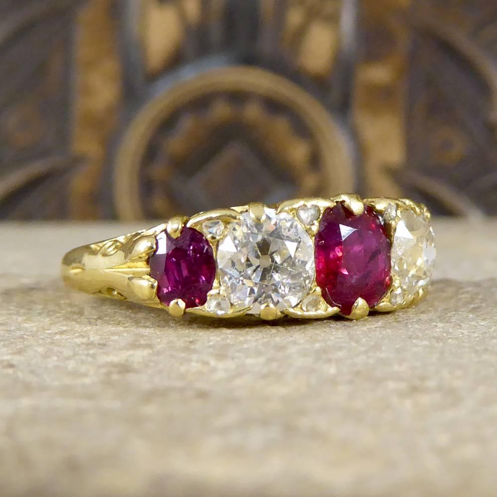 Such a lovely Late Victorian ring with a beautifully detailed 18ct Yellow Gold gallery and carved shoulders. Holding three vibrant Rubies weighing a total of 1.35cts and two Diamonds weighing a total of 1.2cts this gorgeous five stone ring shines
