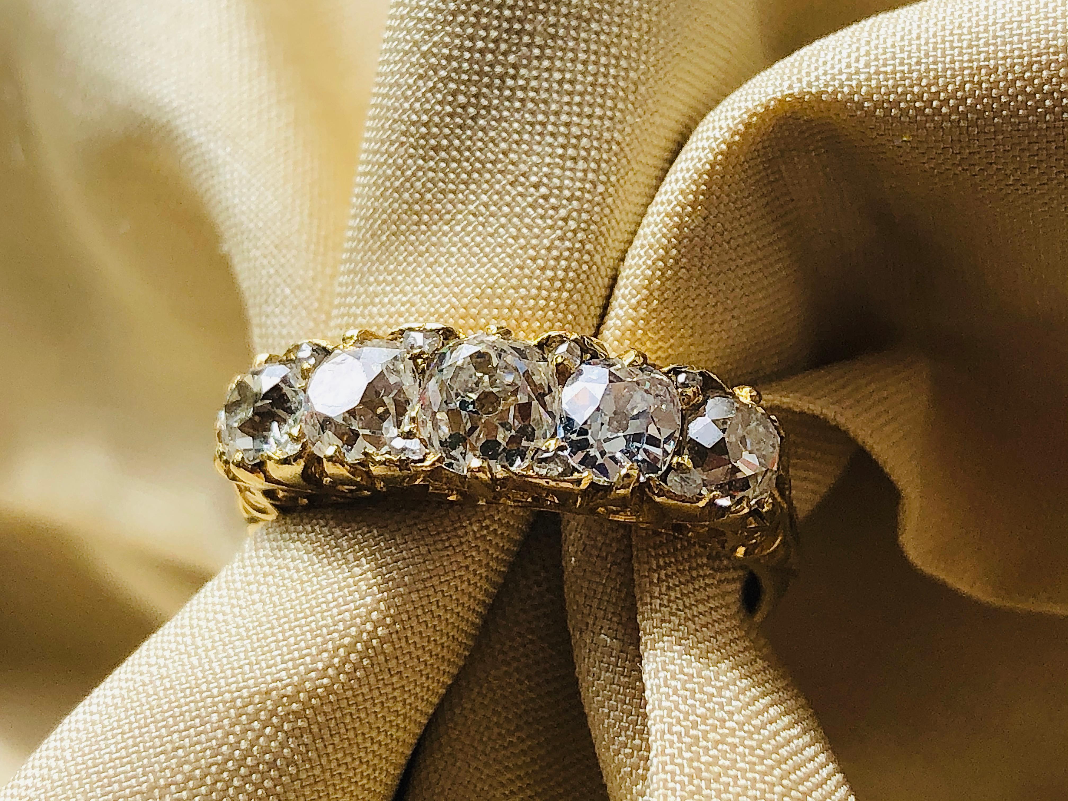Victorian, diamond five stone ring, circa 1880. Set with five beautiful chunky old mine-cut diamonds (1.60ct total) in an intricately carved yellow gold setting. This style of ring is called a carved half hoop. The diamonds in this ring are