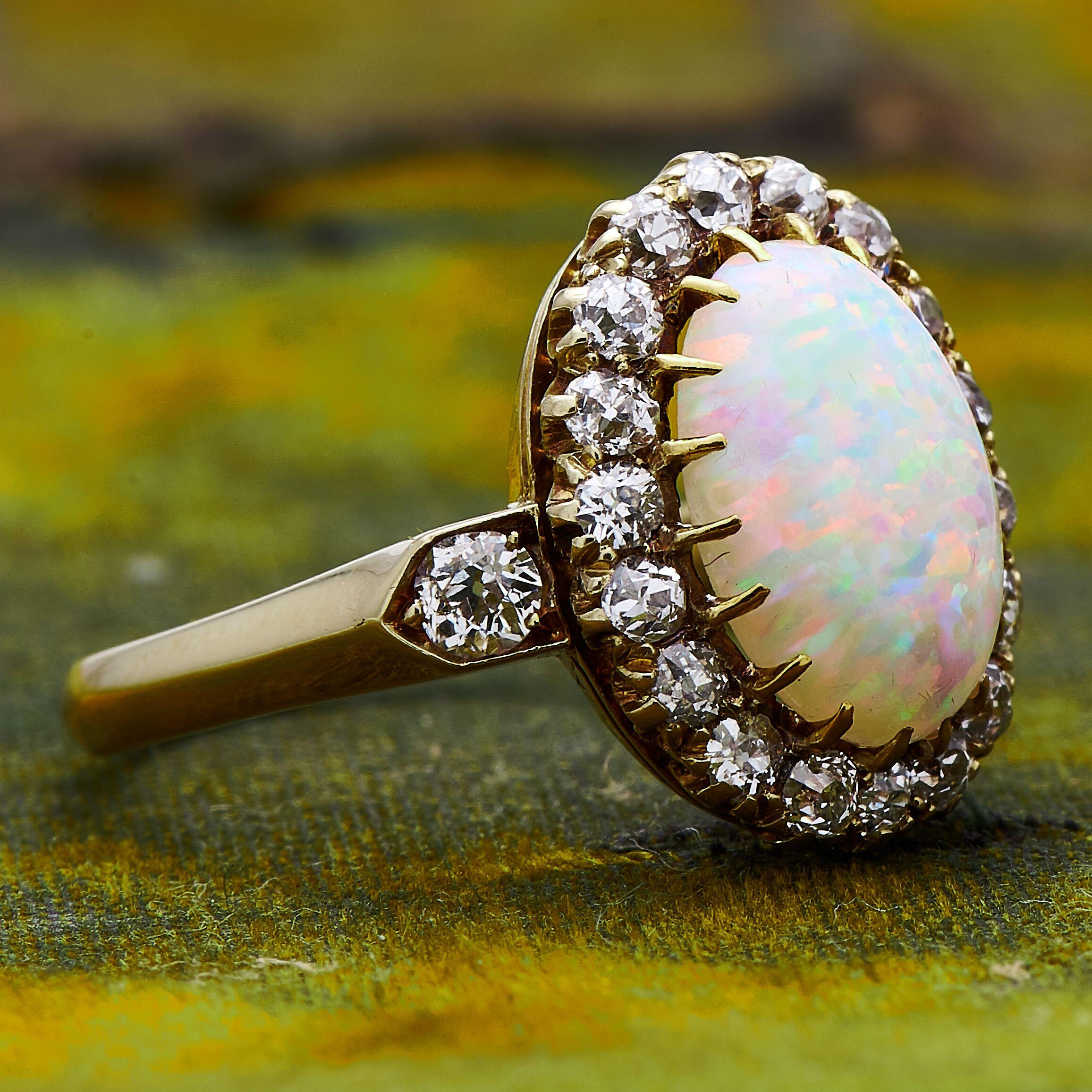 An incredible, 19th century, natural opal (harlequin coloured) and diamond ring, circa 1880. Set to centre a vibrant opal with a wonderful array of all colours encircled by sparkling old-cut diamonds (1ct approximately), a wonderful contrast to the